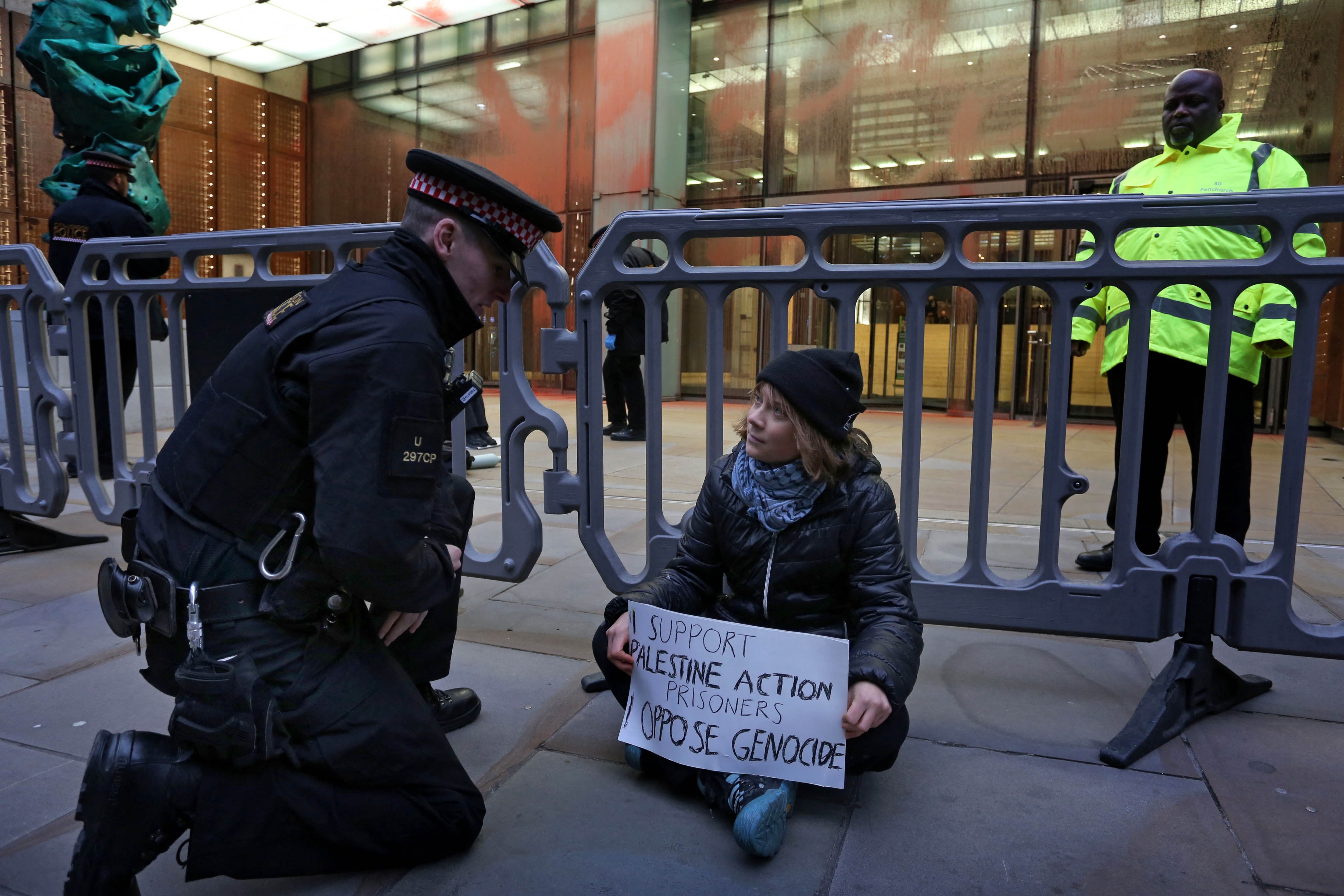 A handout photograph taken on and released by Prisoners for Palestine in London on December 23, 2025 shows Swedish activist Greta Thunberg before her arrest by Police officers outside the offices of Aspen Insurance at Plantation Place on Fenchurch Street. London police on Tuesday arrested Swedish activist Greta Thunberg at a demonstration in support of pro-Palestinian hunger strikers, Palestinian activist groups said. "Greta Thunberg was arrested under the Terrorism Act at the Prisoners for Palestine lock-on protest," Prisoners for Palestine said in a statement. (Photo by Prisoners for Palestine / AFP) / RESTRICTED TO EDITORIAL USE - MANDATORY CREDIT "AFP PHOTO / PRISONERS FOR PALESTINE / HANDOUT " - NO MARKETING NO ADVERTISING CAMPAIGNS - DISTRIBUTED AS A SERVICE TO CLIENTS