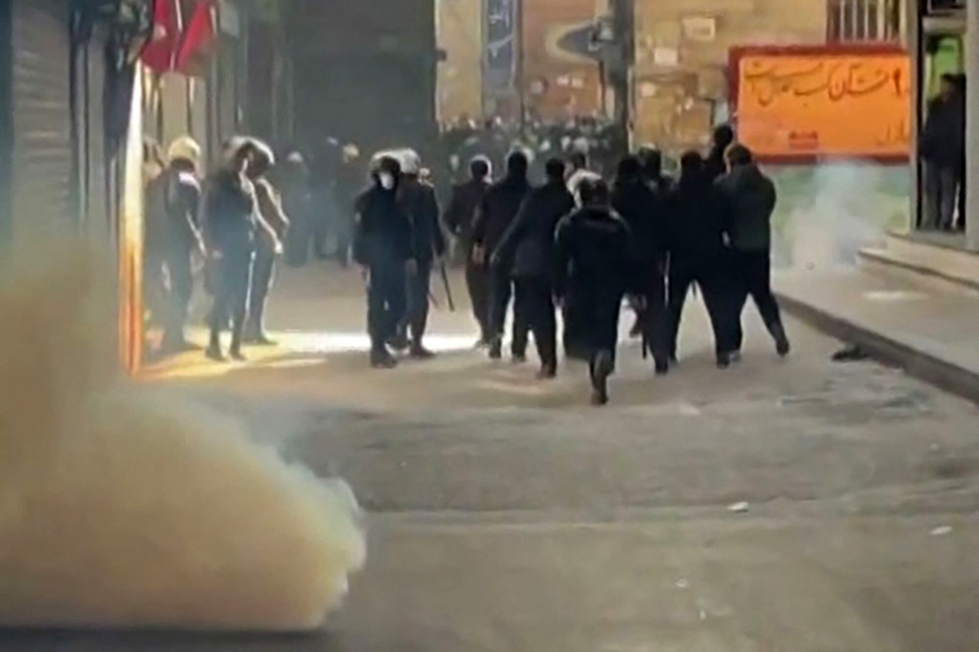 This grab taken on January 6, 2026, from UGC images posted on social media the same day shows Iranian security forces using tear gas to disperse protesters at the Tehran bazaar. Iranian security forces fired tear gas on January 6 to disperse protesters at the Tehran bazaar who were chanting slogans against the clerical authorities, according to rights groups and images posted on social media. The Islamic republic is facing its most serious wave of protests since the 2022-2023 nationwide rallies sparked by the death in custody of Mahsa Amini, who had been arrested for allegedly violating the strict dress code for women. (Photo by UGC / AFP) / Israel OUT / NO USE AFTER JANUARY 16, 2026 13:44:32 GMT - ISRAEL OUT / NO USE AFTER JANUARY 16, 2026 13:44:32 GMT - ISRAEL OUT / RESTRICTED TO EDITORIAL USE - MANDATORY CREDIT "AFP PHOTO / UGC / ANONYMOUS" - NO MARKETING - NO ADVERTISING CAMPAIGNS - NO INTERNET - DISTRIBUTED AS A SERVICE TO CLIENTS - NO RESALE - NO ARCHIVE -NO ACCESS ISRAEL MEDIA/PERSIAN LANGUAGE TV STATIONS OUTSIDE IRAN/ STRICTLY NO ACCESS BBC PERSIAN/ VOA PERSIAN/ MANOTO-1 TV/ IRAN INTERNATIONAL/RADIO FARDA - AFP IS NOT RESPONSIBLE FOR ANY DIGITAL ALTERATIONS TO THE PICTURE'S EDITORIAL CONTENT /