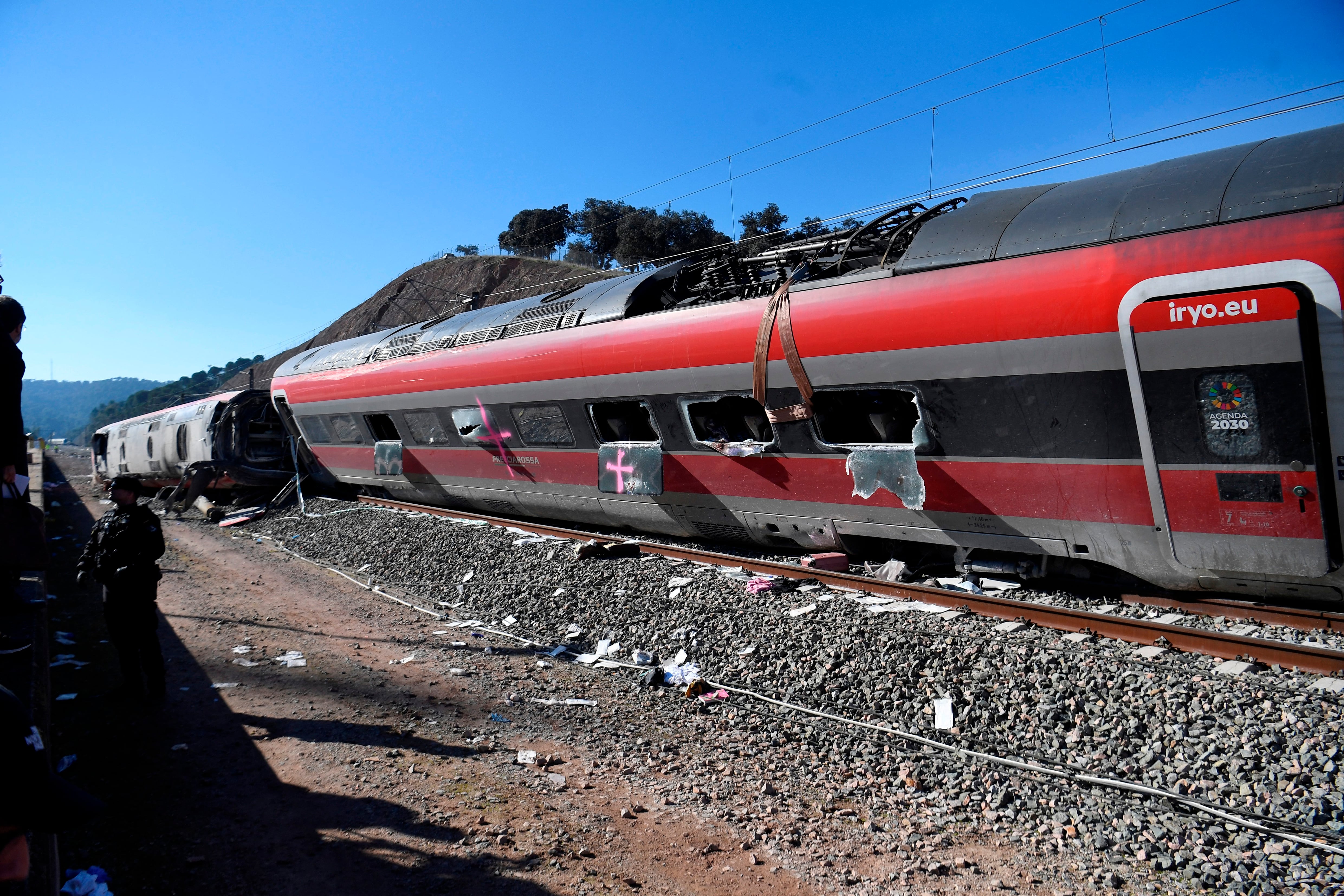 A picture taken on January 20, 2026 shows a view of a high-speed Iryo train that derailed and hit another train two days before, in Adamuz, southern Spain. At least 41 people died and more than 120 injured in the deadliest train accident in Spain in over a decade. The crash happened on January 18 evening when a train operated by rail company Iryo travelling from Malaga to Madrid derailed near Adamuz, crossing onto the other track where it crashed into an oncoming train, which also derailed. (Photo by CRISTINA QUICLER / AFP)