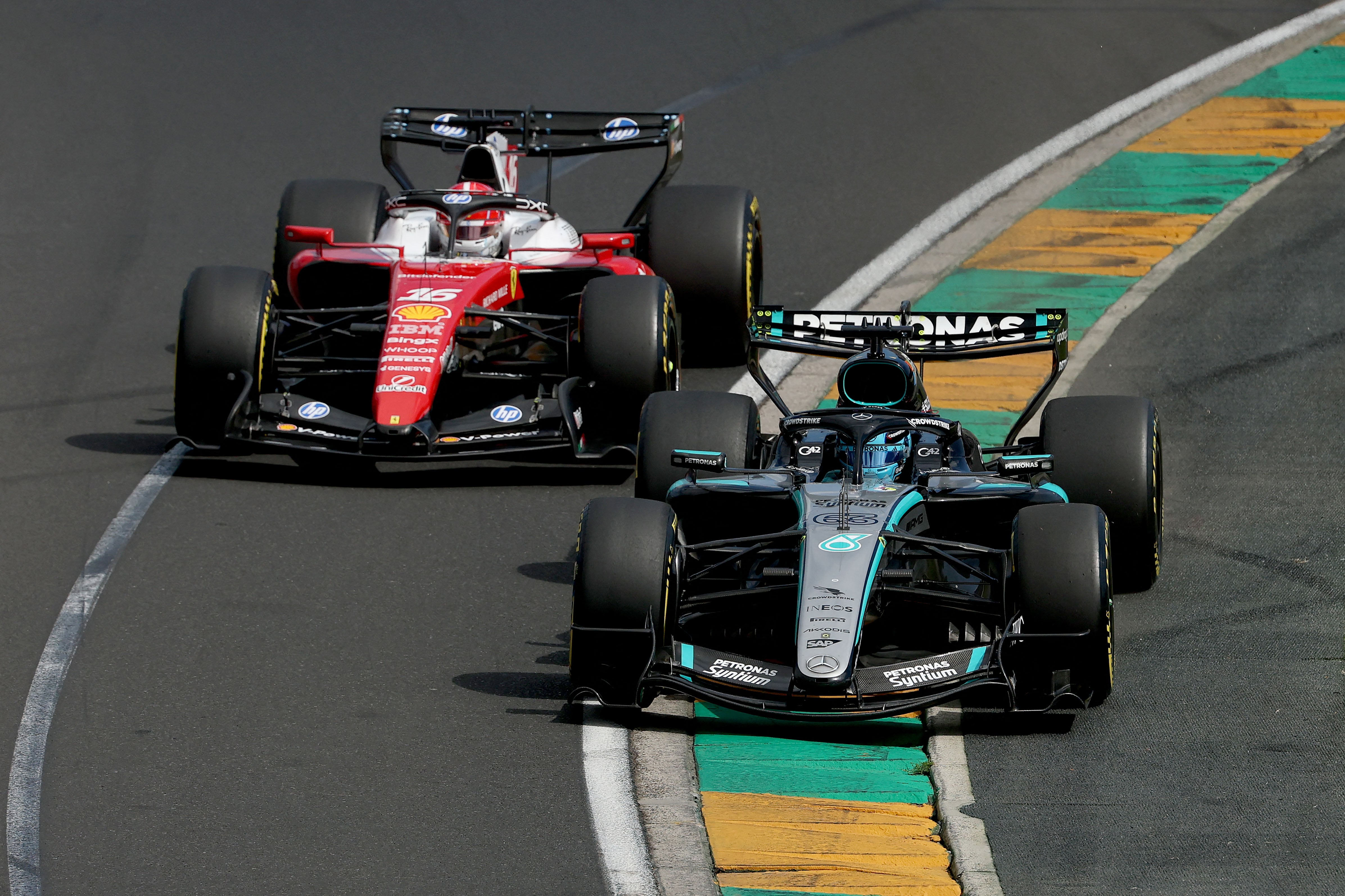 Mercedes' British driver George Russell (R) competes with Ferrari's Monegasque driver Charles Leclerc during the Formula One Australian Grand Prix at Melbourne’s Albert Park Circuit on March 8, 2026. (Photo by Martin KEEP / AFP) / -- IMAGE RESTRICTED TO EDITORIAL USE - STRICTLY NO COMMERCIAL USE --