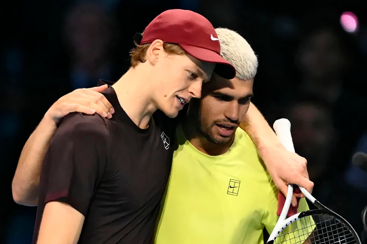 Italy's Jannik Sinner (L) is congratulated by Spain's Carlos Alcaraz at the end of their men's single final match at the ATP Finals tennis tournament, in Turin, on November 16, 2025. (Photo by Marco BERTORELLO / AFP)