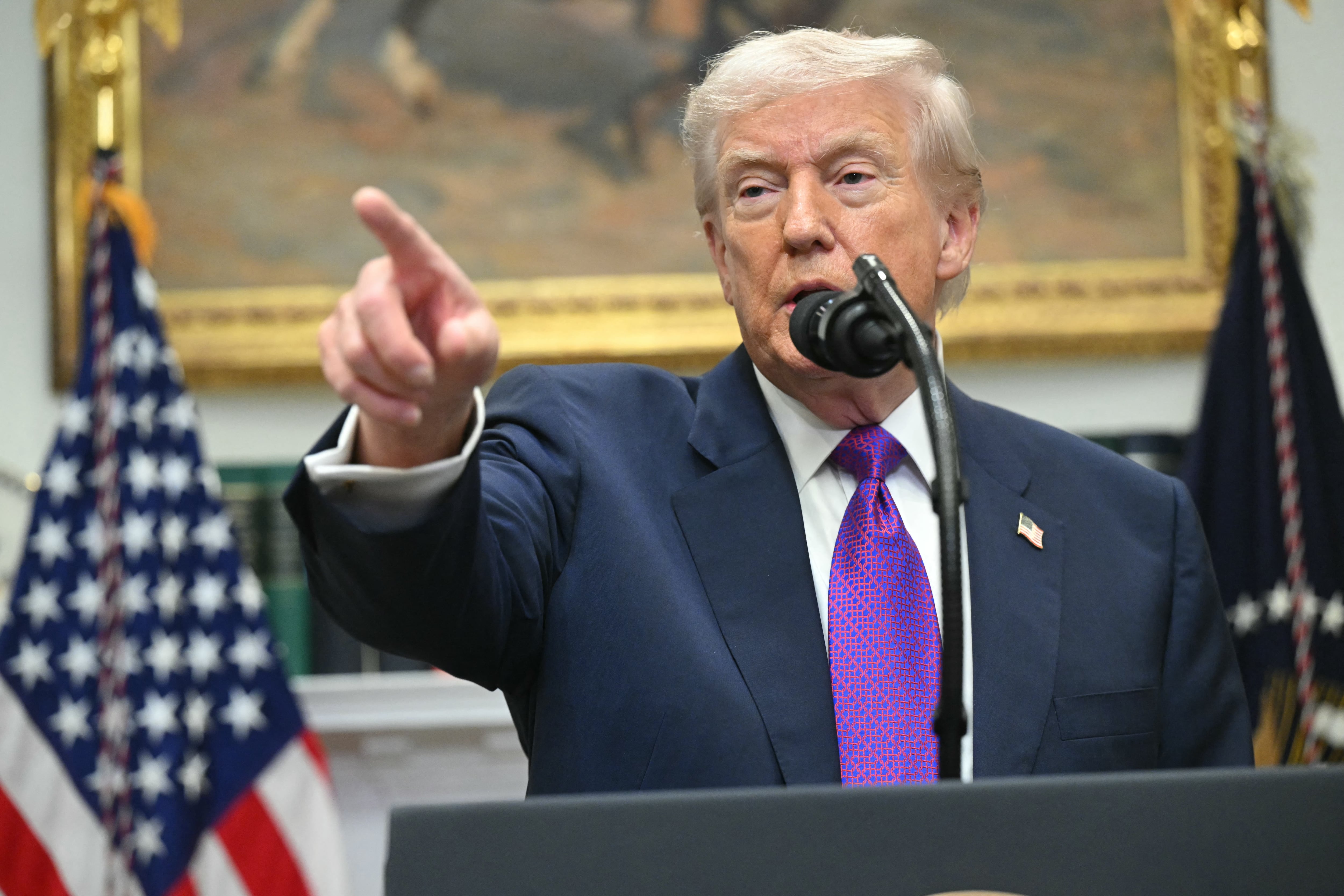 US President Donald Trump takes questions from reporters as after he made an announcement in the Roosevelt Room of the White House