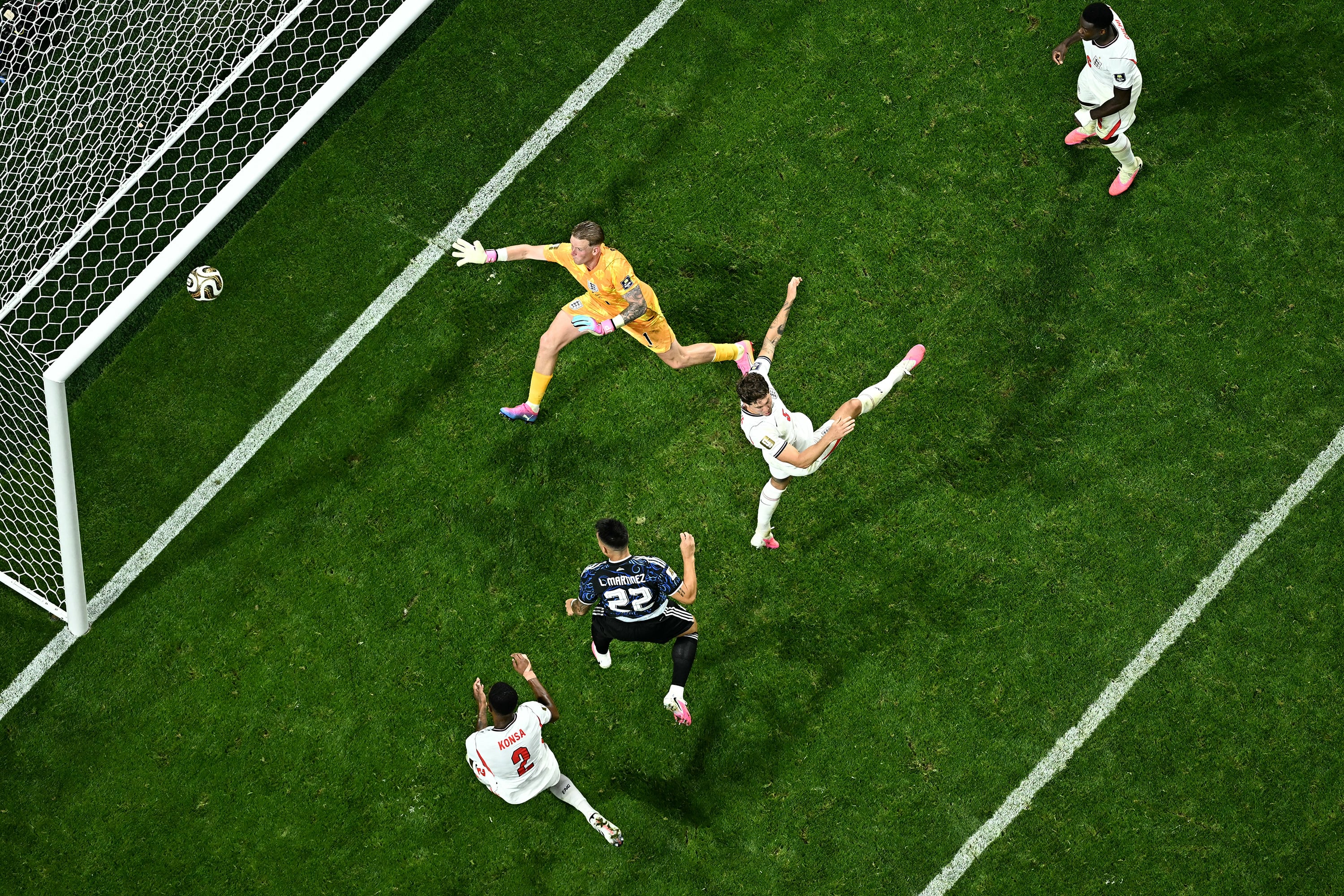 Argentina's forward #22 Lautaro Martinez scores his team's second goal past England's goalkeeper #01 Jordan Pickford during the 2026 World Cup