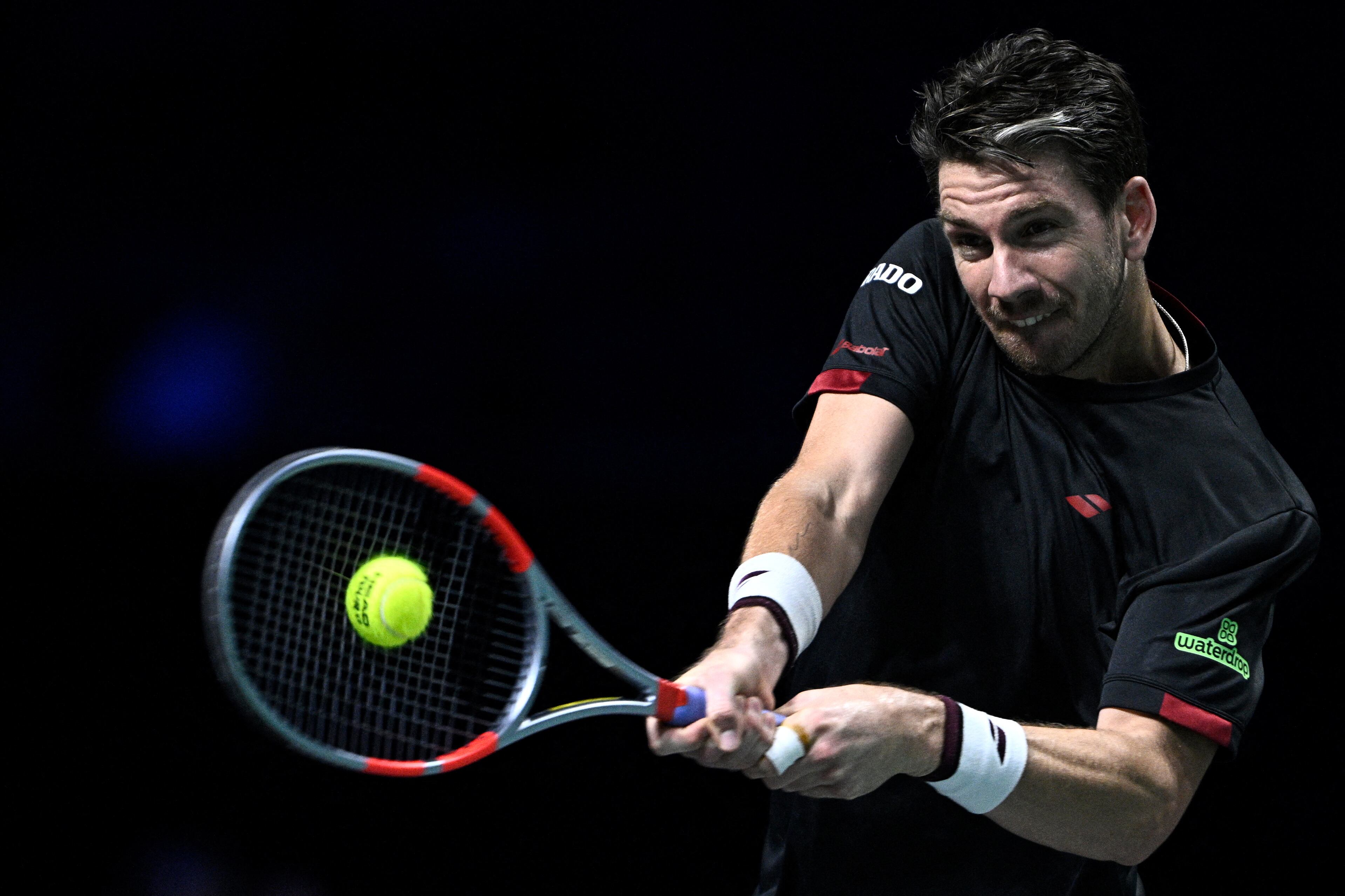 Britain's Cameron Norrie plays a backhand return to Monaco's Valentin Vacherot during their men's singles match on day four of the Paris ATP Masters 1000 tennis tournament at the Paris La Défense Arena in Nanterre, on the outskirts of Paris, on October 30, 2025. (Photo by JULIEN DE ROSA / AFP)