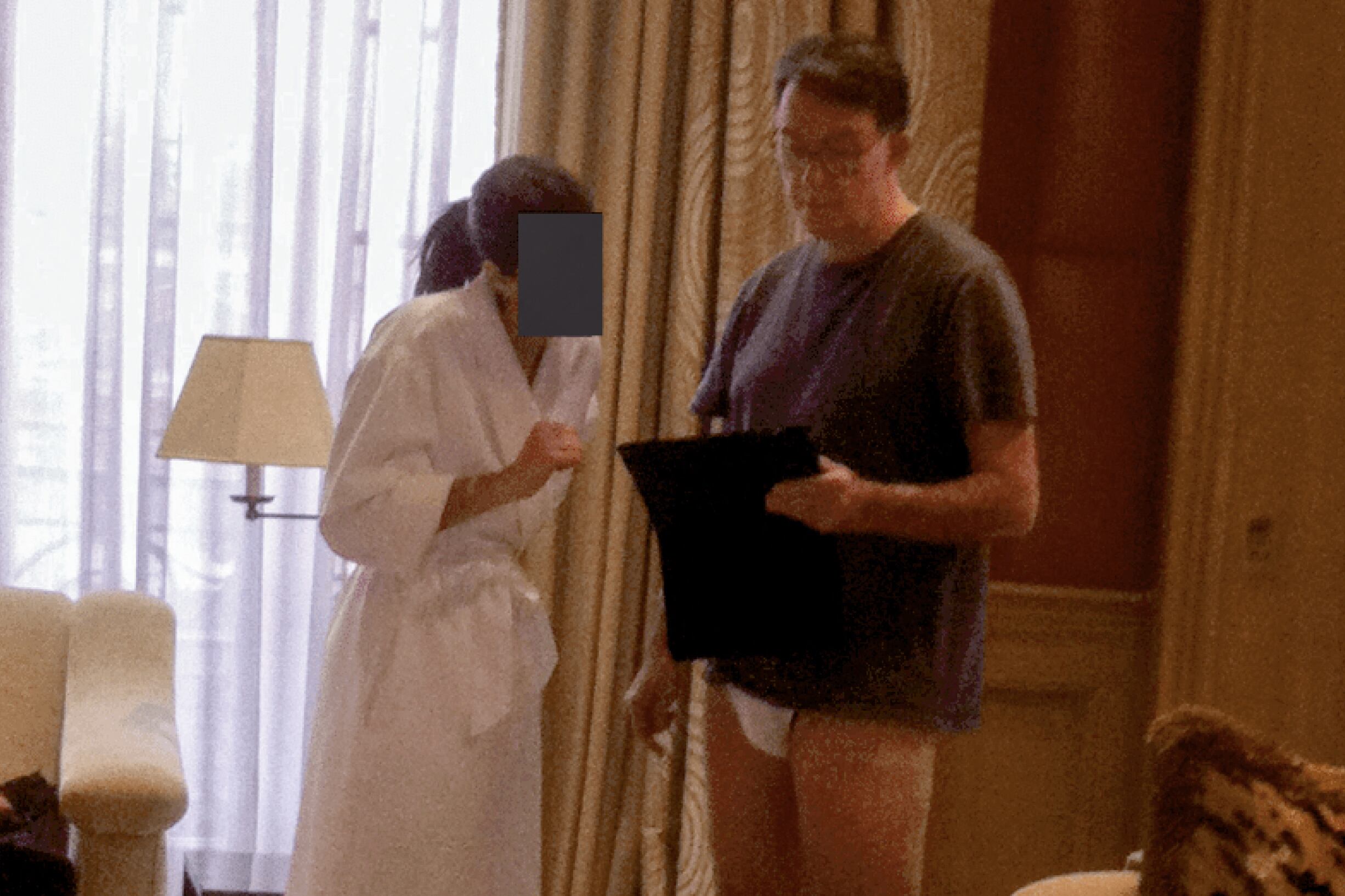 This undated photo in an unidentified location provided by the US Department of Justice on December 19, 2025 shows former UK Ambassador in the US Peter Mandelson in his underwear next to a woman whose face has been redacted. Epstein Files Transparency Act (EFTA) passed by Congress and signed into law by US President Donald Trump mandated the complete release of the Epstein files by December 19, 2025. (Photo by Handout / US Department of Justice / AFP) / RESTRICTED TO EDITORIAL USE - MANDATORY CREDIT "AFP PHOTO / US DEPARTMENT OF JUSTICE" - HANDOUT - NO MARKETING NO ADVERTISING CAMPAIGNS - DISTRIBUTED AS A SERVICE TO CLIENTS