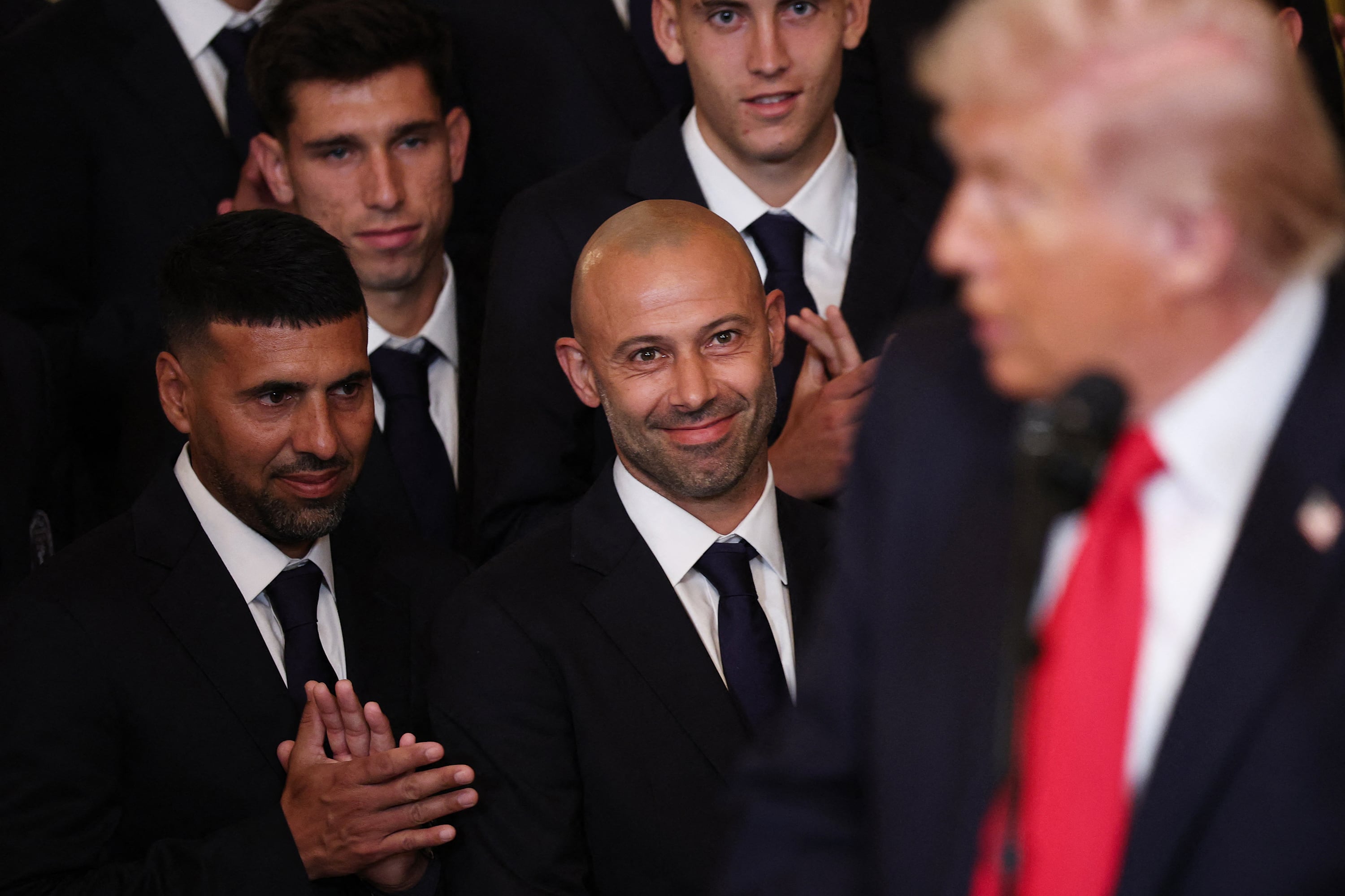 MARCH 05: Head Coach Javier Mascherano (2L) of the Inter Miami CF smiles as U.S. President Donald Trump speaks during an event celebrating the 2025 MLS Cup Champions Inter Miami CF in the East Room of the White House on March 05, 2026 in Washington, DC