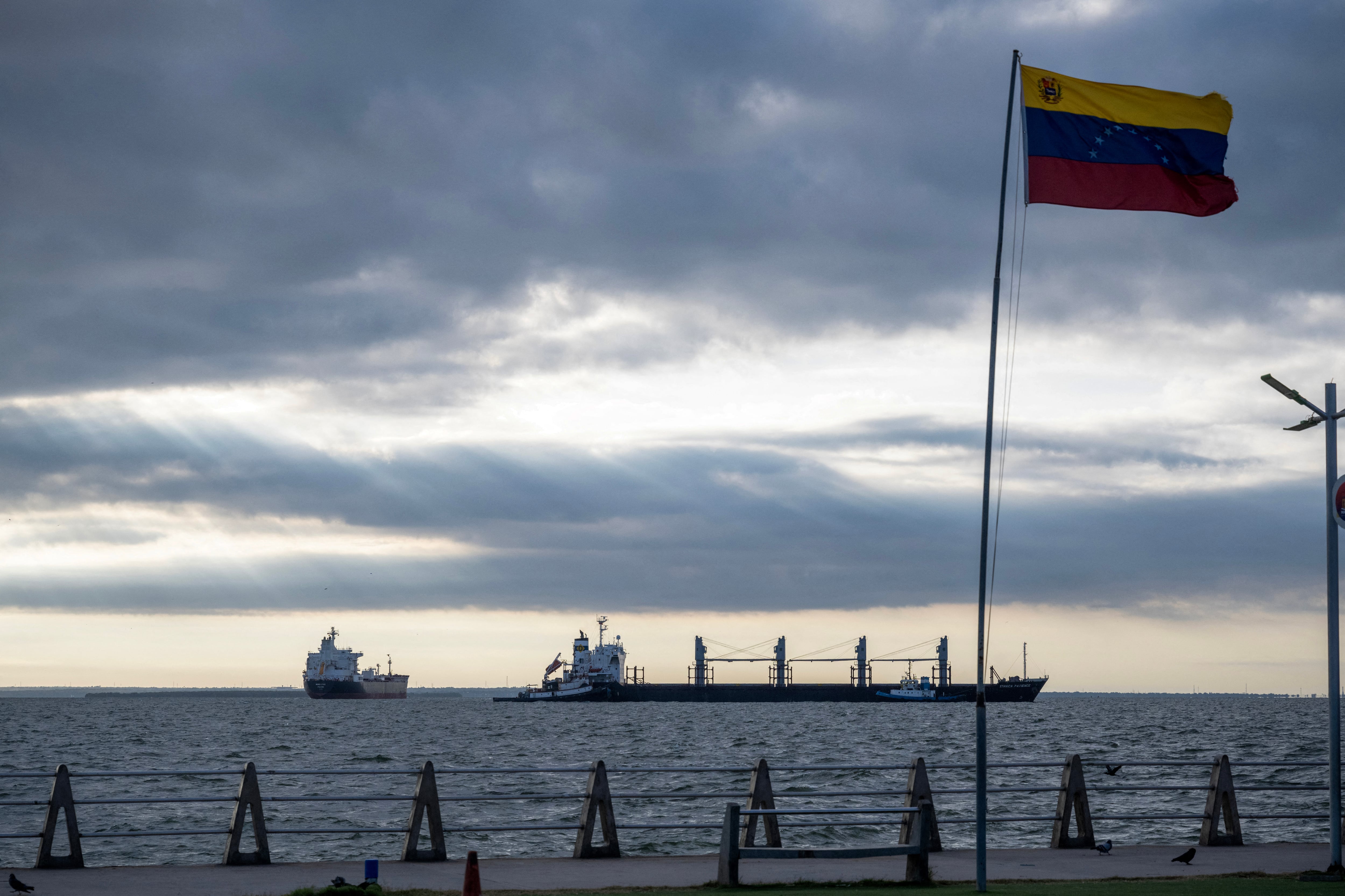 This view shows the bulk carrier Ithaca Patience (R) and the crude oil tanker Nord Star, both from Panama, anchored on Lake Maracaibo, Venezuela on January 7, 2026. US Energy Secretary Chris Wright said in January 7, Washington will control sales of Venezuelan oil "indefinitely," a day after President Donald Trump announced Venezuela's interim leaders had agreed to US-managed marketing of 30-50 million barrels of crude. (Photo by Maryorin Mendez / AFP)