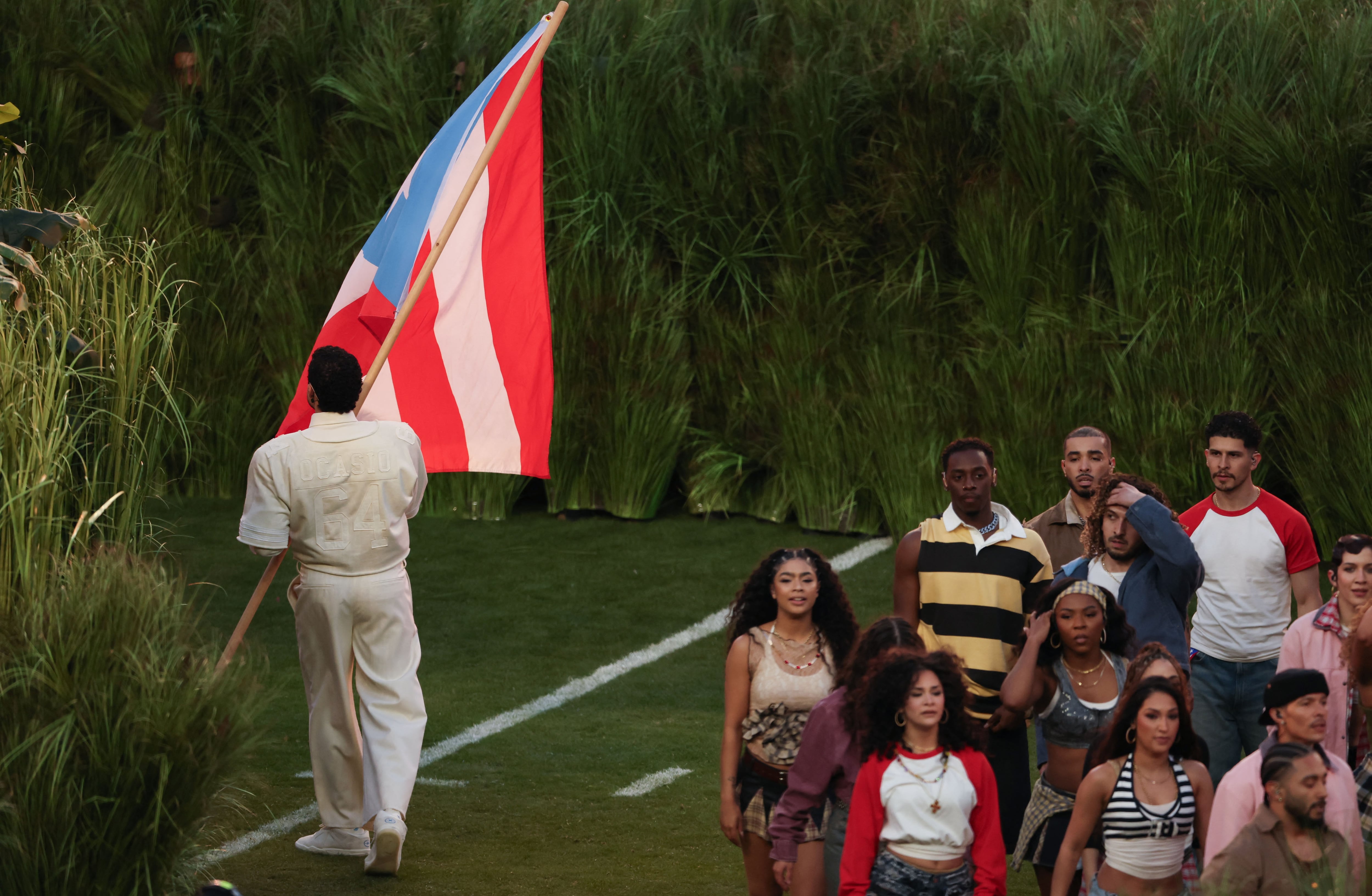 Puerto Rican singer Bad Bunny waves a Puerto Rican flag during Super Bowl LX Patriots vs Seahawks Apple Music Halftime Show at Levi's Stadium in Santa Clara, California on February 8, 2026. (Photo by Patrick T. Fallon / AFP)