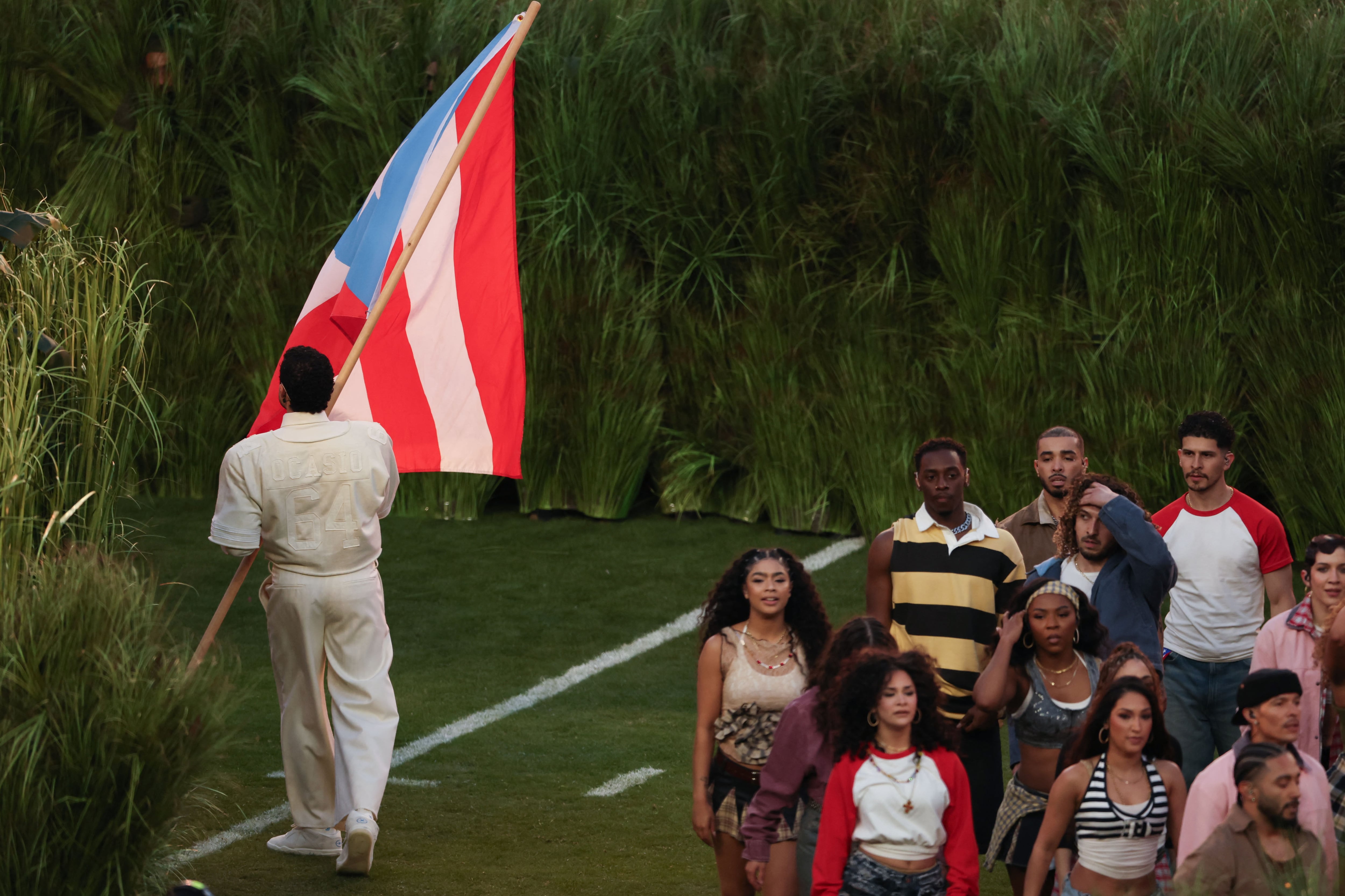 Puerto Rican singer Bad Bunny waves a Puerto Rican flag during Super Bowl LX Patriots vs Seahawks Apple Music Halftime Show at Levi's Stadium in Santa Clara, California on February 8, 2026. (Photo by Patrick T. Fallon / AFP)