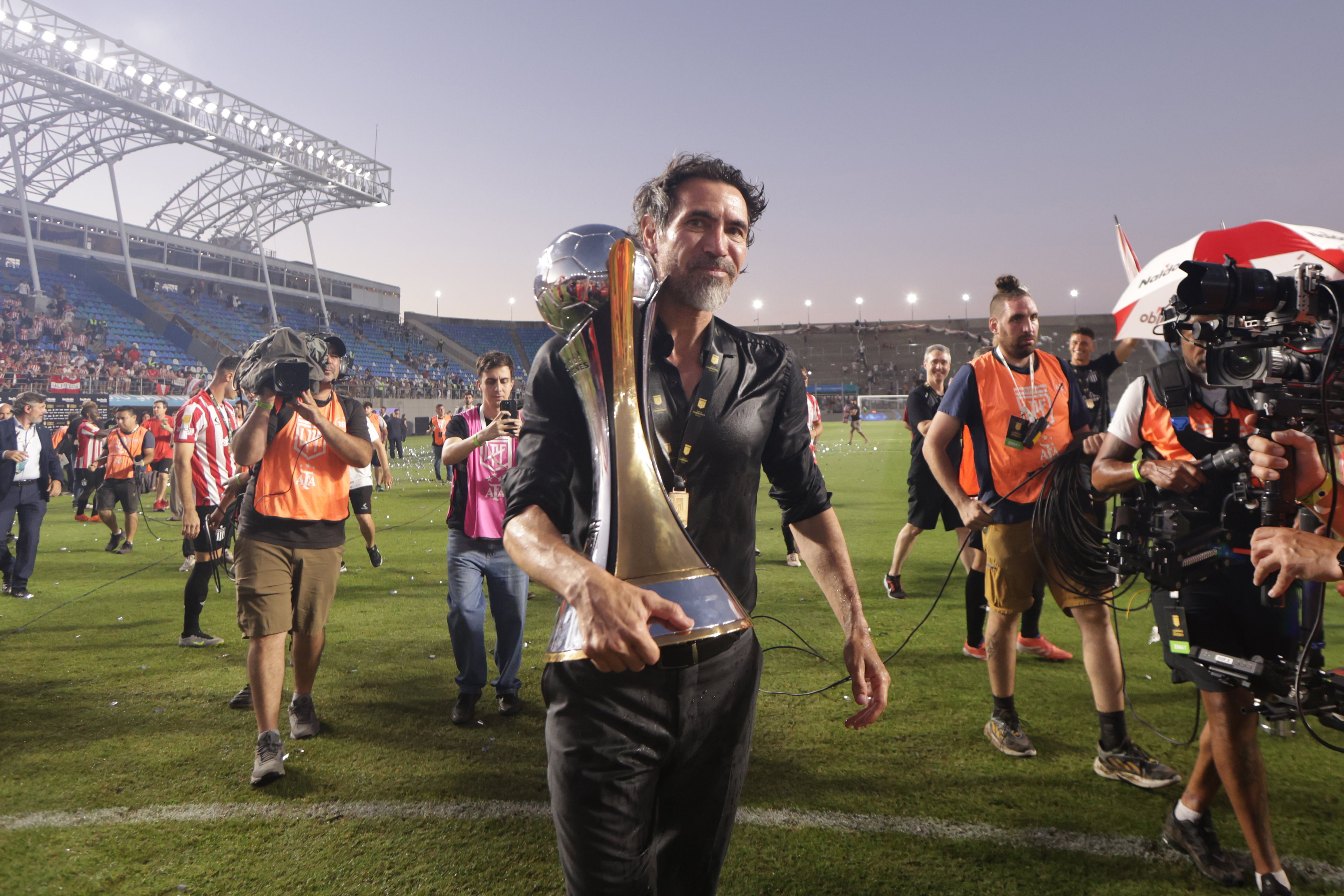 AMDEP133. SAN NICOLÁS (ARGENTINA), 20/12/2025.- El entrenador de Estudiantes Eduardo Domínguez sostiene un trofeo este sábado, luego de ganar la final del Trofeo de Campeones entre el Club Estudiantes de La Plata y el Club Atlético Platense en el Estadio Único de San Nicolás, en San Nicolás (Argentina). EFE/ Adan González