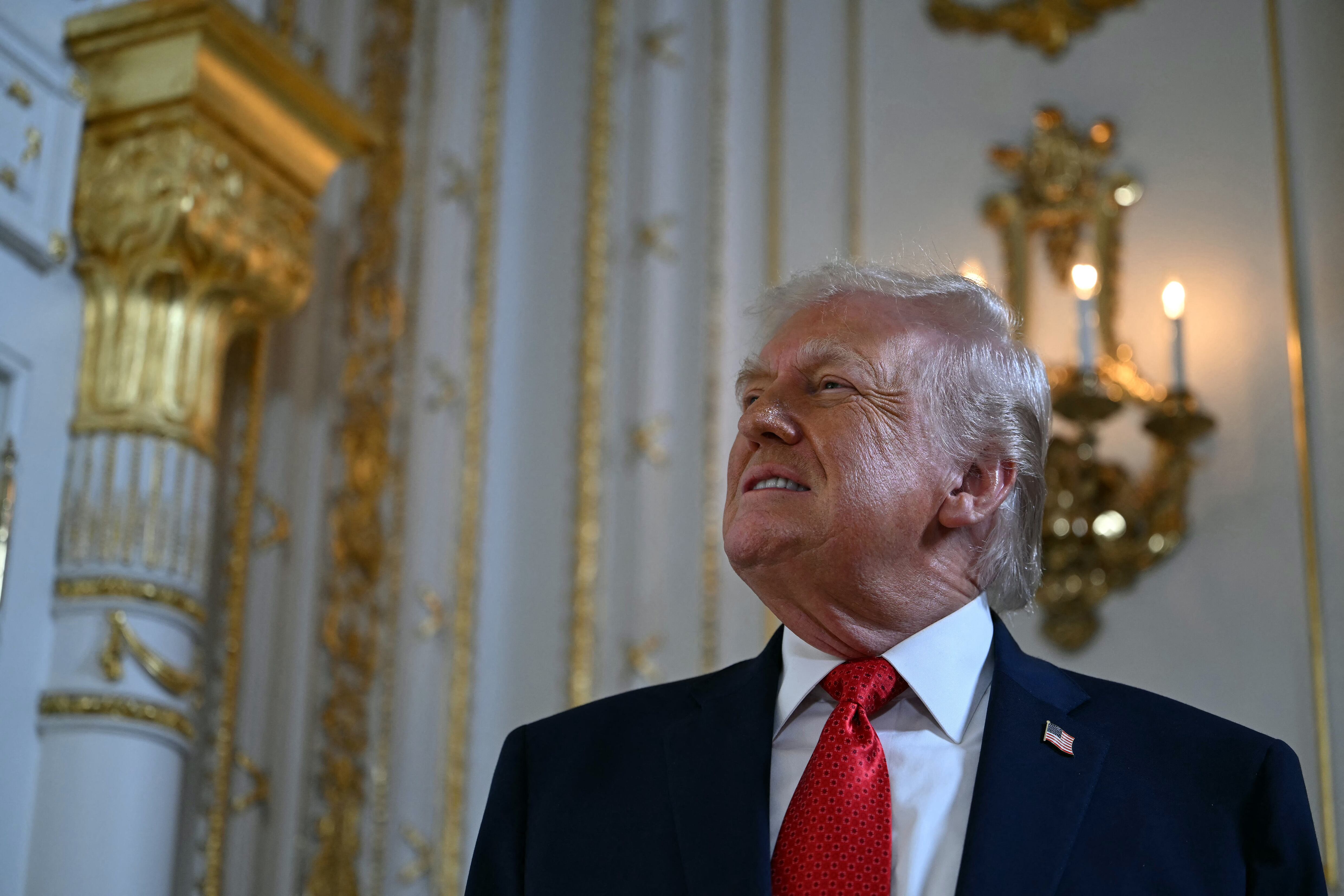 US President Donald Trump arrives to take part in a dedication ceremony for Southern Boulevard, in the ballroom at Mar-a-Lago in Palm Beach, Florida, on January 16, 2026. (Photo by ANDREW CABALLERO-REYNOLDS / AFP)