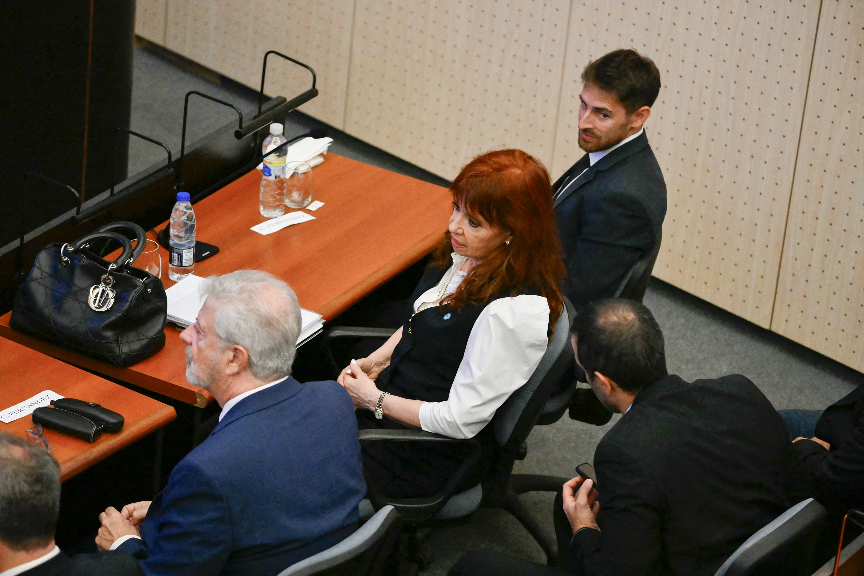 Former Argentine president (2007–2015) Cristina Kirchner (C) sits next to her lawyers at the Comodoro Py courthouse in Buenos Aires on March 17, 2026.