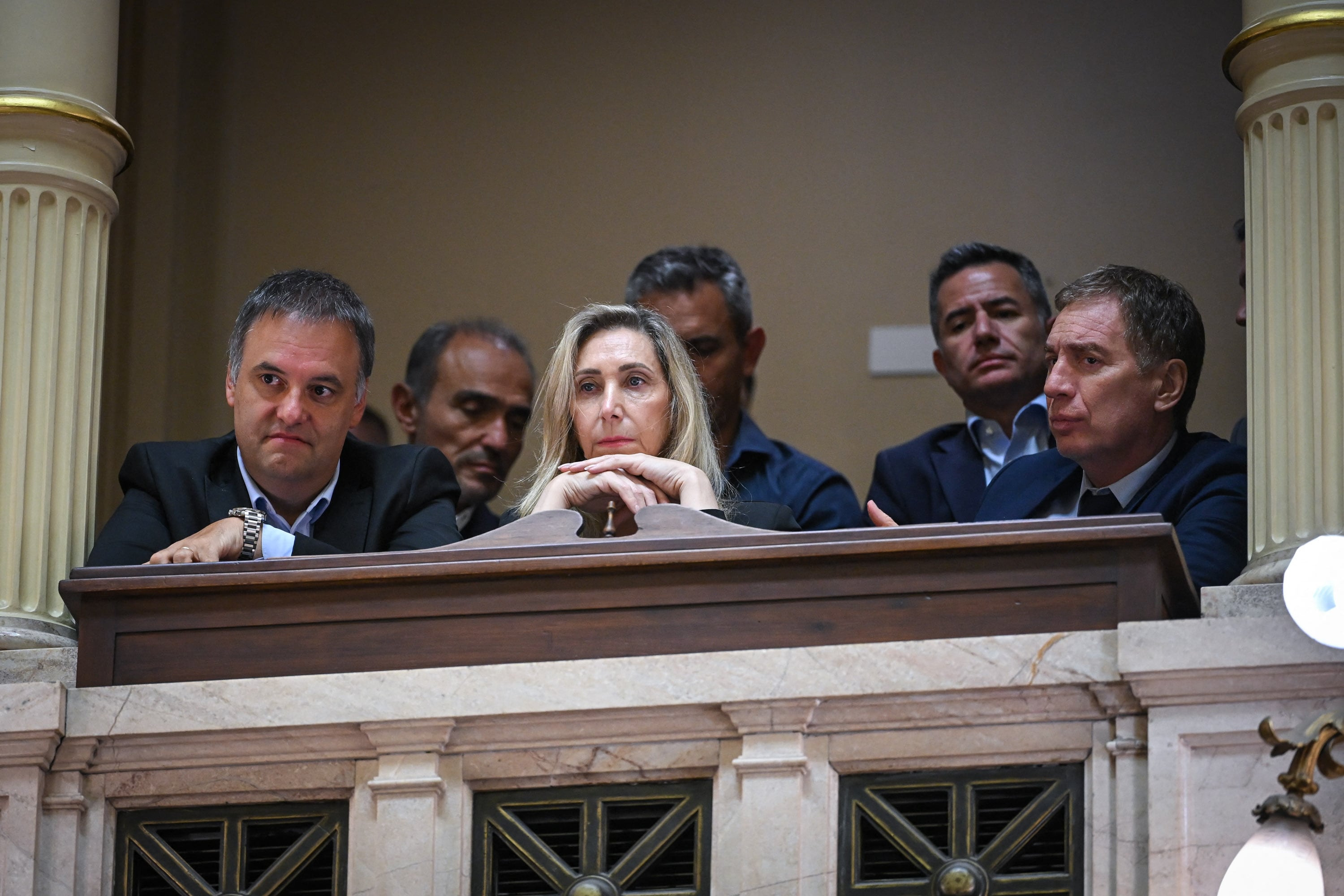 Handout photo released by the press office of the Argentine Senate shows Argentinas Secretary General of the Presidency Karina Milei (C), Argentinas Chief Cabinet Manuel Adorni (L) and Argentinas Minister of the Interior Diego Santilli (R) attending the debate on labor reforms at the Senate of the Argentine Congress in Buenos Aires on February 12, 2026. Argentina pushed closer on February 12 to approving labor reforms that have triggered clashes between workers and police in the streets outside Congress.