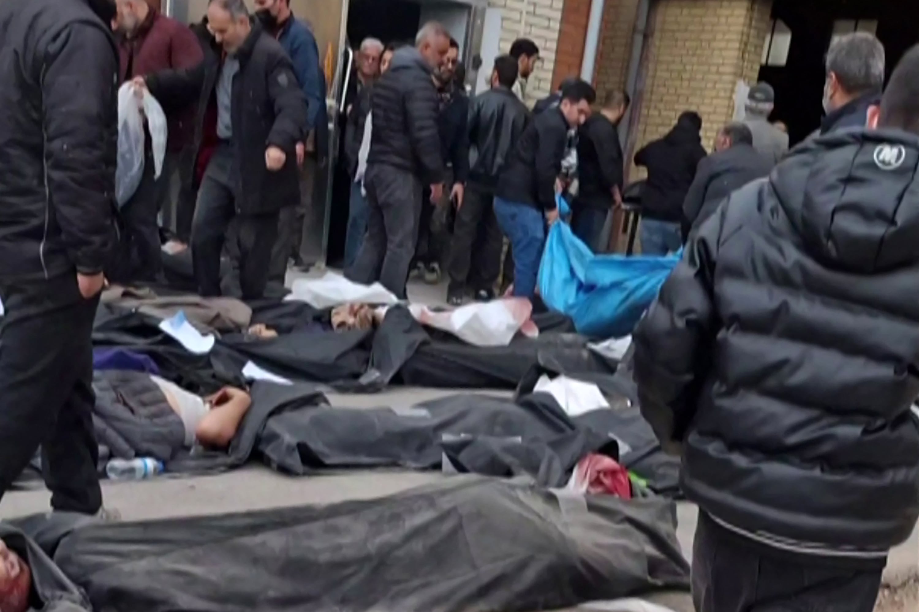 EDITORS NOTE: Graphic content / This video grab taken on January 14, 2026 from UGC images posted on social media on January 13, 2026, shows bodies lying on the ground at the Tehran Province Forensic Diagnostic and Laboratory Centre in Kahrizak, as grieving relatives search for their loved ones. Other videos showing the same scenes first appeared online on January 10, 2026.
A violent crackdown on a wave of protests in Iran has killed at least 648 people, a rights group said on January 12, 2026, as Iranian authorities sought to regain control of the streets with mass nationwide rallies. (Photo by UGC / AFP) / Israel OUT / ISRAEL OUT / ISRAEL OUT / RESTRICTED TO EDITORIAL USE - MANDATORY CREDIT AFP - SOURCE: ANONYMOUS - NO MARKETING - NO ADVERTISING CAMPAIGNS - DISTRIBUTED AS A SERVICE TO CLIENTS - NO RESALE - NO ACCESS ISRAEL MEDIA/PERSIAN LANGUAGE TV STATIONS OUTSIDE IRAN/ STRICTLY NO ACCESS BBC PERSIAN/ VOA PERSIAN/ MANOTO-1 TV/ IRAN INTERNATIONAL/RADIO FARDA - AFP IS NOT RESPONSIBLE FOR ANY DIGITAL ALTERATIONS TO THE PICTURE'S EDITORIAL CONTENT /