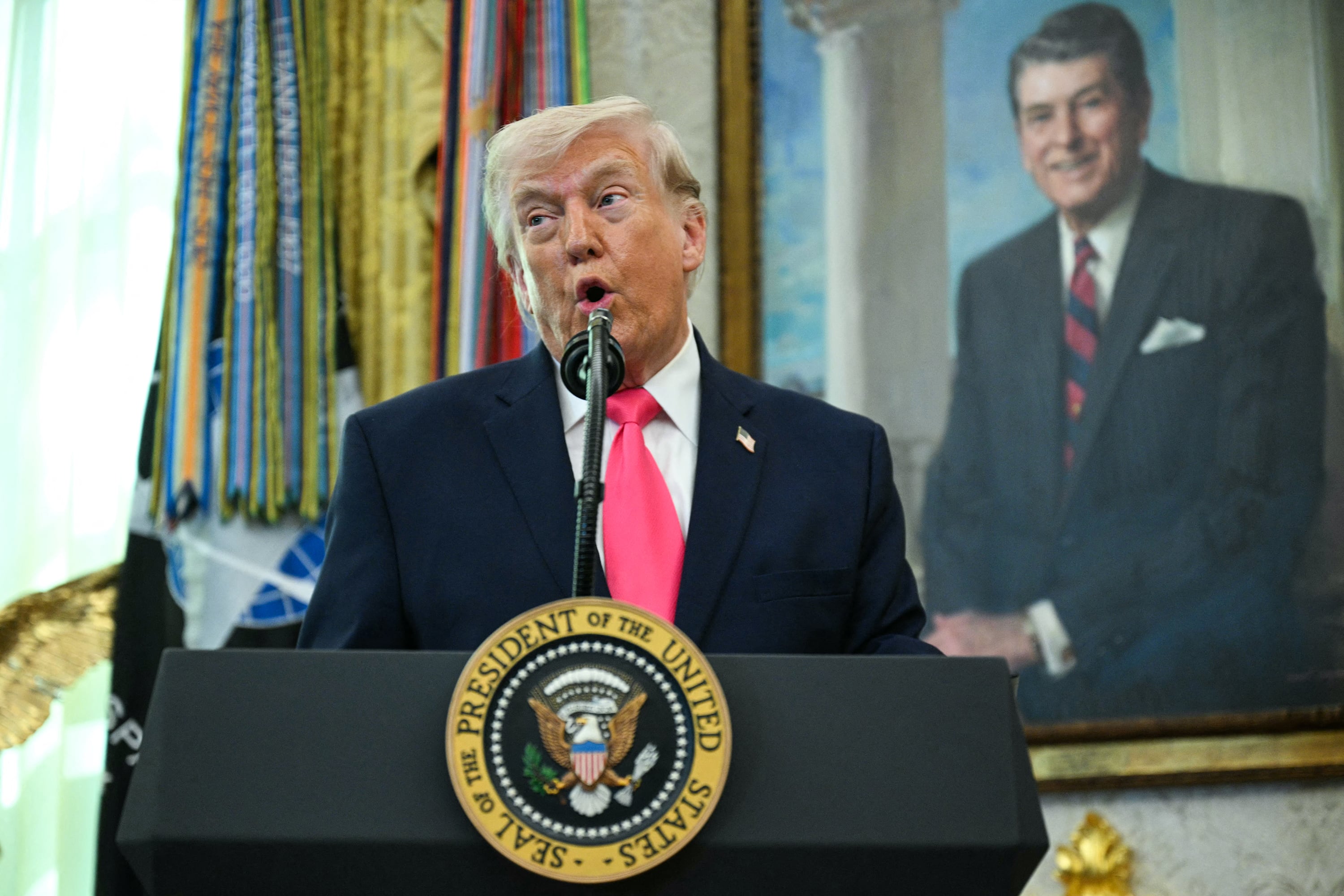 US President Donald Trump speaks before swearing in the new Secretary of Homeland Security Markwayne Mullin in the Oval Office of the White House in Washington, DC, on March 24, 2026.