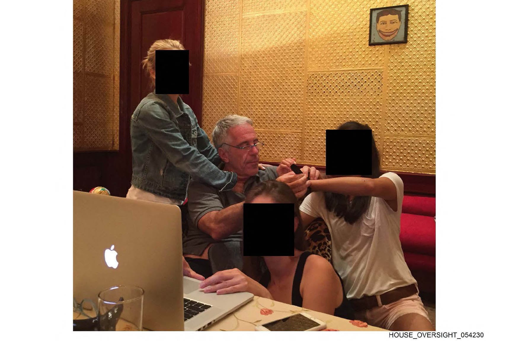 This undated and unlocated handout image released by Democrats on the House Oversight Committee on December 18, 2025 shows late convicted sex offender Jeffrey Epstein (2L) sitting next to women whose faces have been redacted. Democratic lawmakers released a new cache of photos and documents on December 18 from the estate of convicted sex offender Jeffrey Epstein. (Photo by House Oversight Democrats / AFP) / RESTRICTED TO EDITORIAL USE - MANDATORY CREDIT "AFP PHOTO /  HOUSE OVERSIGHT COMMITTEE DEMOCRATS  " - HANDOUT - NO MARKETING NO ADVERTISING CAMPAIGNS - DISTRIBUTED AS A SERVICE TO CLIENTS