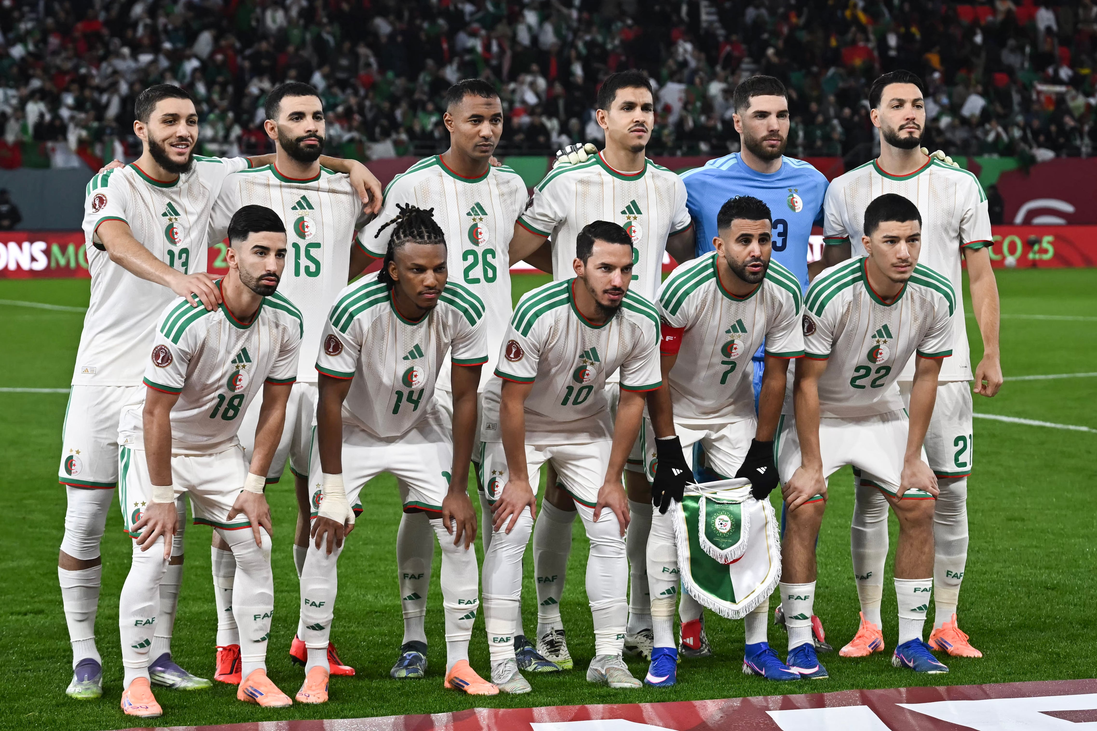(From L to R, 1st row) Algeria's forward #18 Mohamed Amoura, Algeria's midfielder #14 Hicham Boudaoui, Algeria's midfielder #10 Ismael Bennacer, Algeria's forward #7 Riyad Mahrez, Algeria's midfielder #22 Ibrahim Maza, (From L to r, 2nd row) Algeria's defender #13 Jaouen Hadjam, Algeria's defender #15 Rayan Ait-Nouri, Algeria's defender #26 Samir Chergui, Algeria's defender #2 Aissa Mandi, Algeria's goalkeeper #23 Luca Zidane and Algeria's defender #21 Ramy Bensebaini pose before the Africa Cup of Nations (CAN) Group E football match between Algeria and Burkino Faso at Moulay Hassan Stadium in Rabat on December 28, 2025. (Photo by Paul ELLIS / AFP)