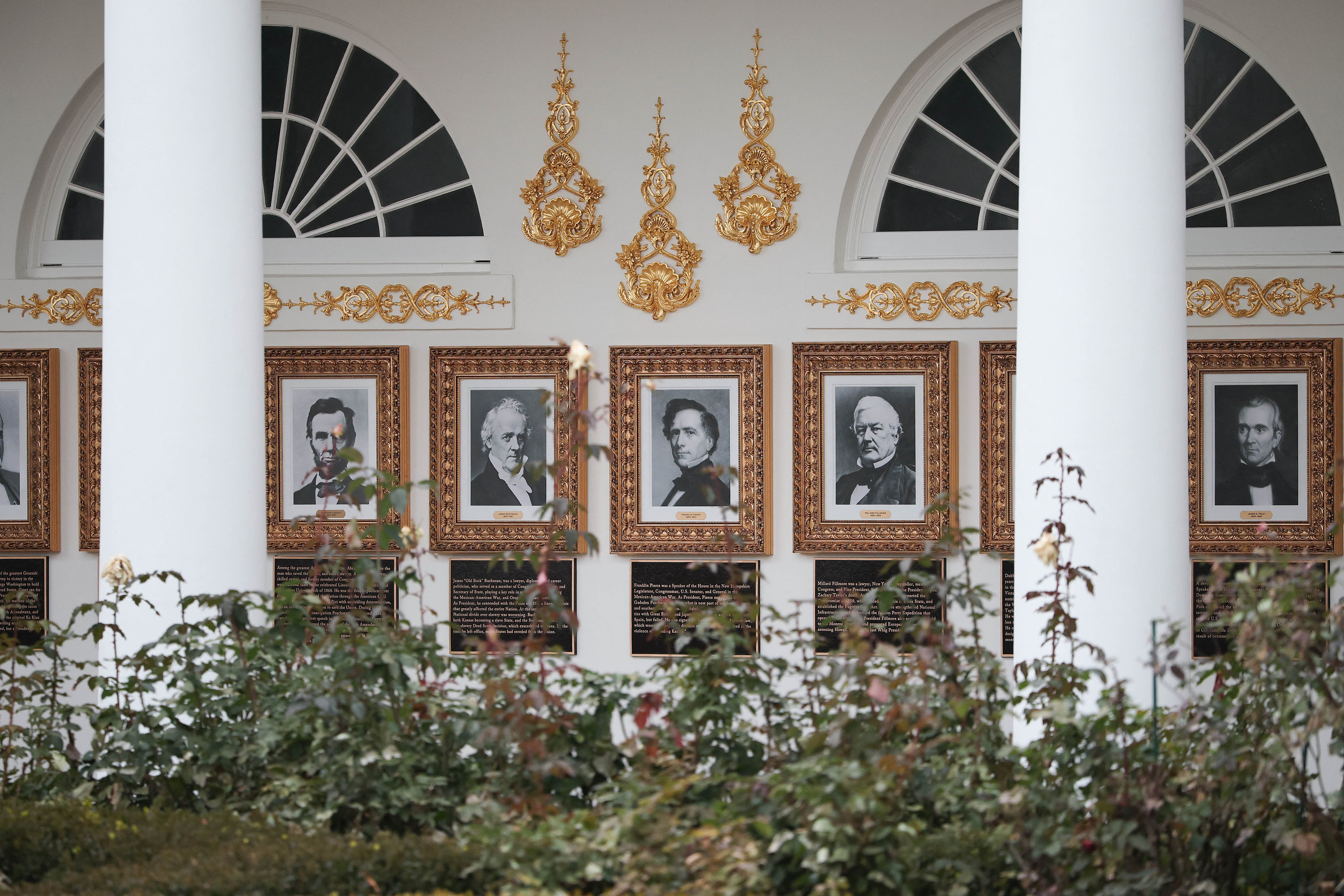 WASHINGTON, DC - DECEMBER 17: Newly installed plaques summarizing the legacies as interpreted by the Trump White House of former U.S. Presidents Abraham Lincoln, James Buchanan, Franklin Pierce, and Millard Fillmore are shown along the colonnade, or the “Presidential Walk of Fame”, December 17, 2025 in Washington, DC. The colonnade lines the north side of the Rose Garden, which has been recently been partially covered with paving stones. Win McNamee/Getty Images/AFP (Photo by WIN MCNAMEE / GETTY IMAGES NORTH AMERICA / Getty Images via AFP)