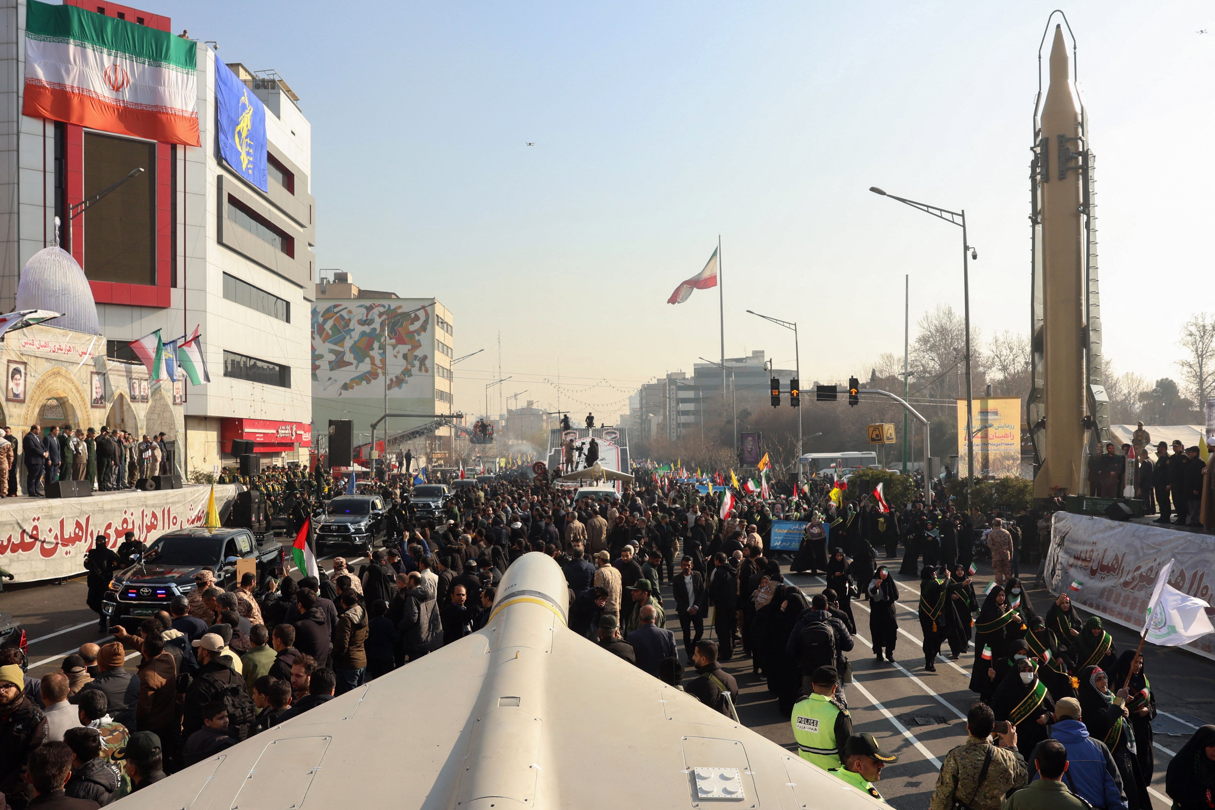 Members of Iranian paramilitary forces (Basij) march next to a Iranian long range Sejil missile, during an anti-Israeli rally to show their solidarity with the Palestinian and Lebanese people, in Tehran, January 10, 2025. (Photo by AFP)