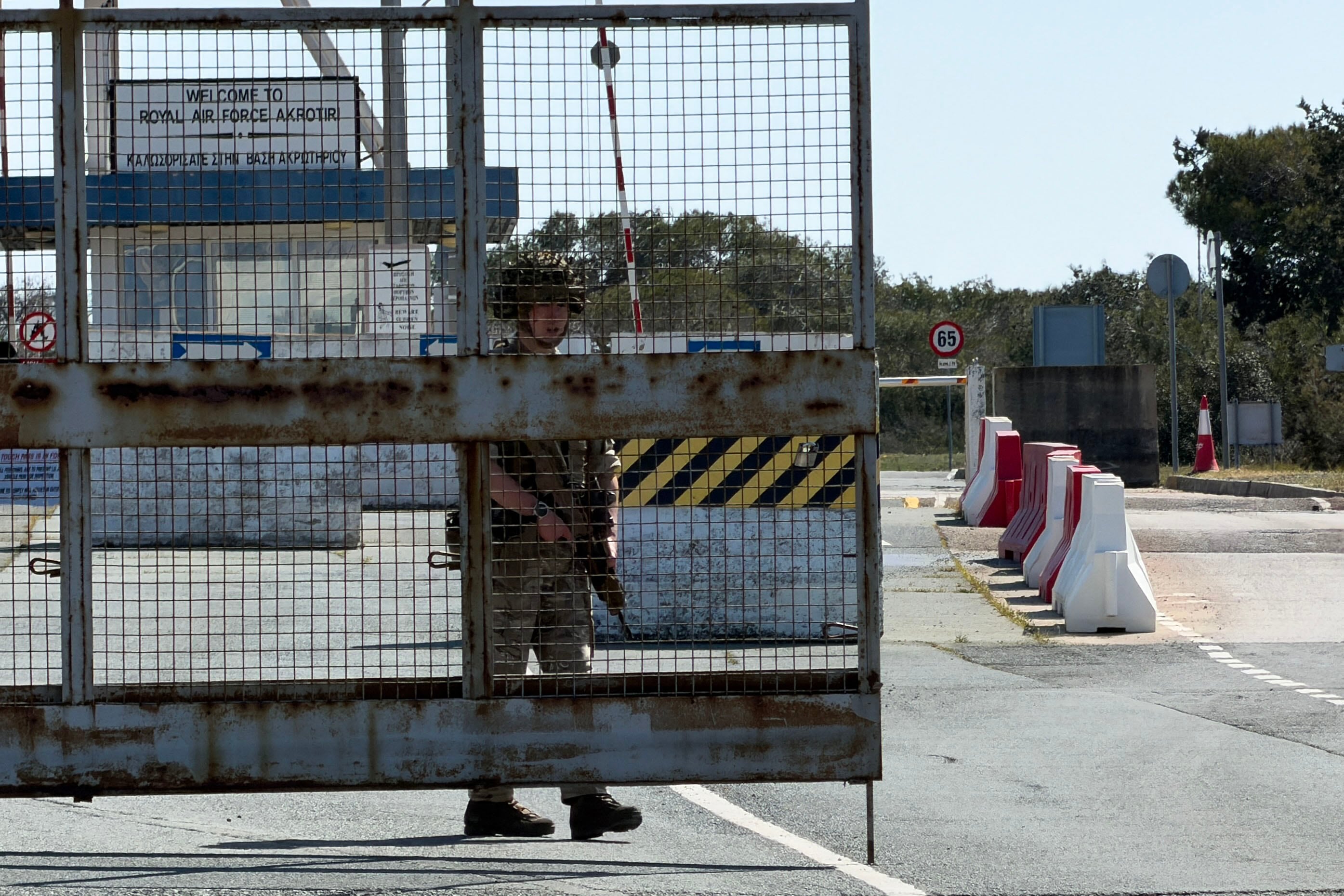 A British soldier mans a gate at RAF Akrotiri base following two reported drone attacks near Limassol on March 2, 2026. The British sovereign base in Cyprus was being evacuated on March after sirens sounded, an AFP correspondent said. (Photo by Etienne TORBEY / AFP)