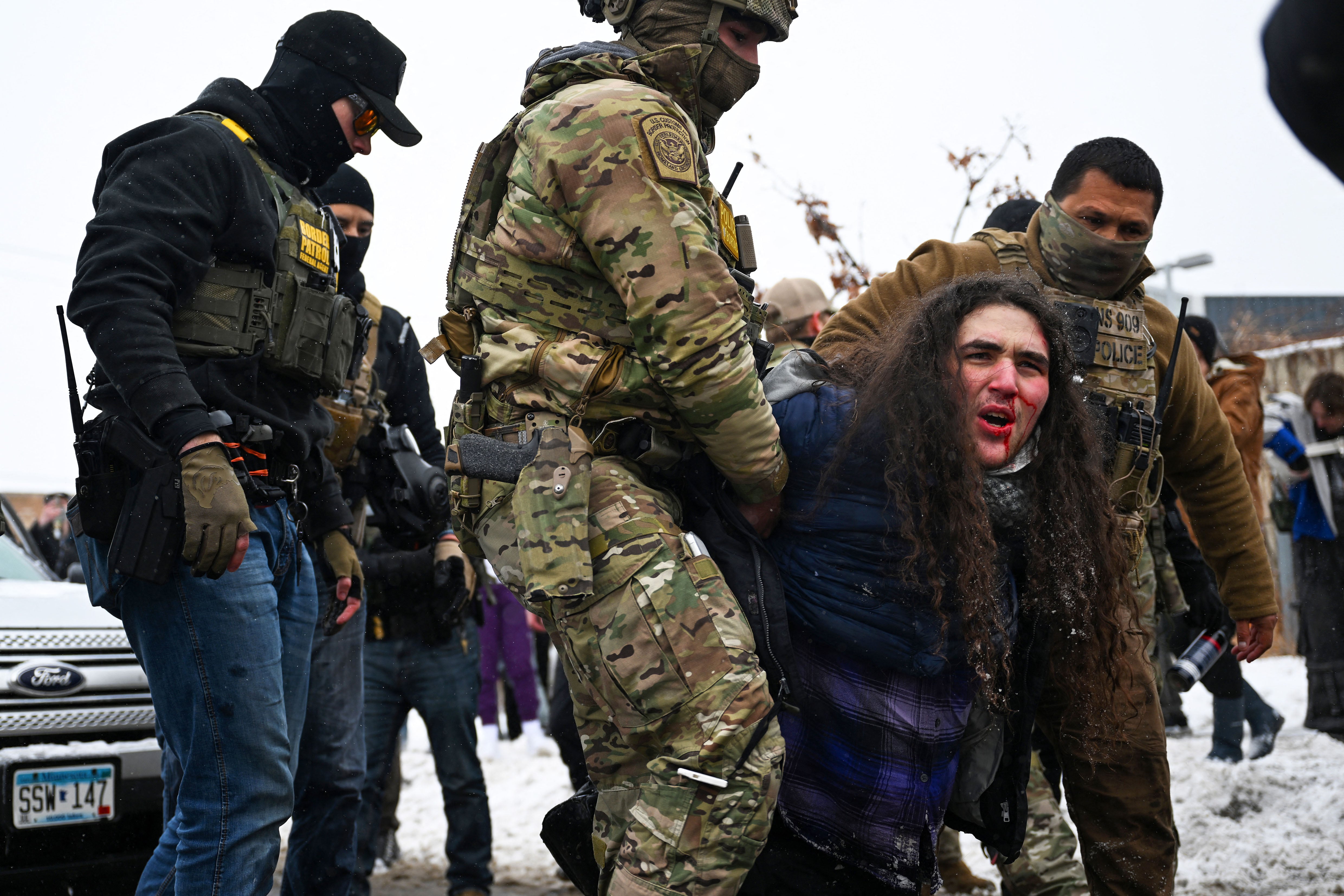 MINNEAPOLIS, MINNESOTA - JANUARY 21: A person is detained by U.S. Border Patrol agents during a confrontation in an intersection on January 21, 2026 in Minneapolis, Minnesota. A reported 3,000 Department of Homeland Security federal agents have been deployed to the state, with more on the way, amid the Trump administration's major crackdown on immigration enforcement.   Brandon Bell/Getty Images/AFP (Photo by Brandon Bell / GETTY IMAGES NORTH AMERICA / Getty Images via AFP)