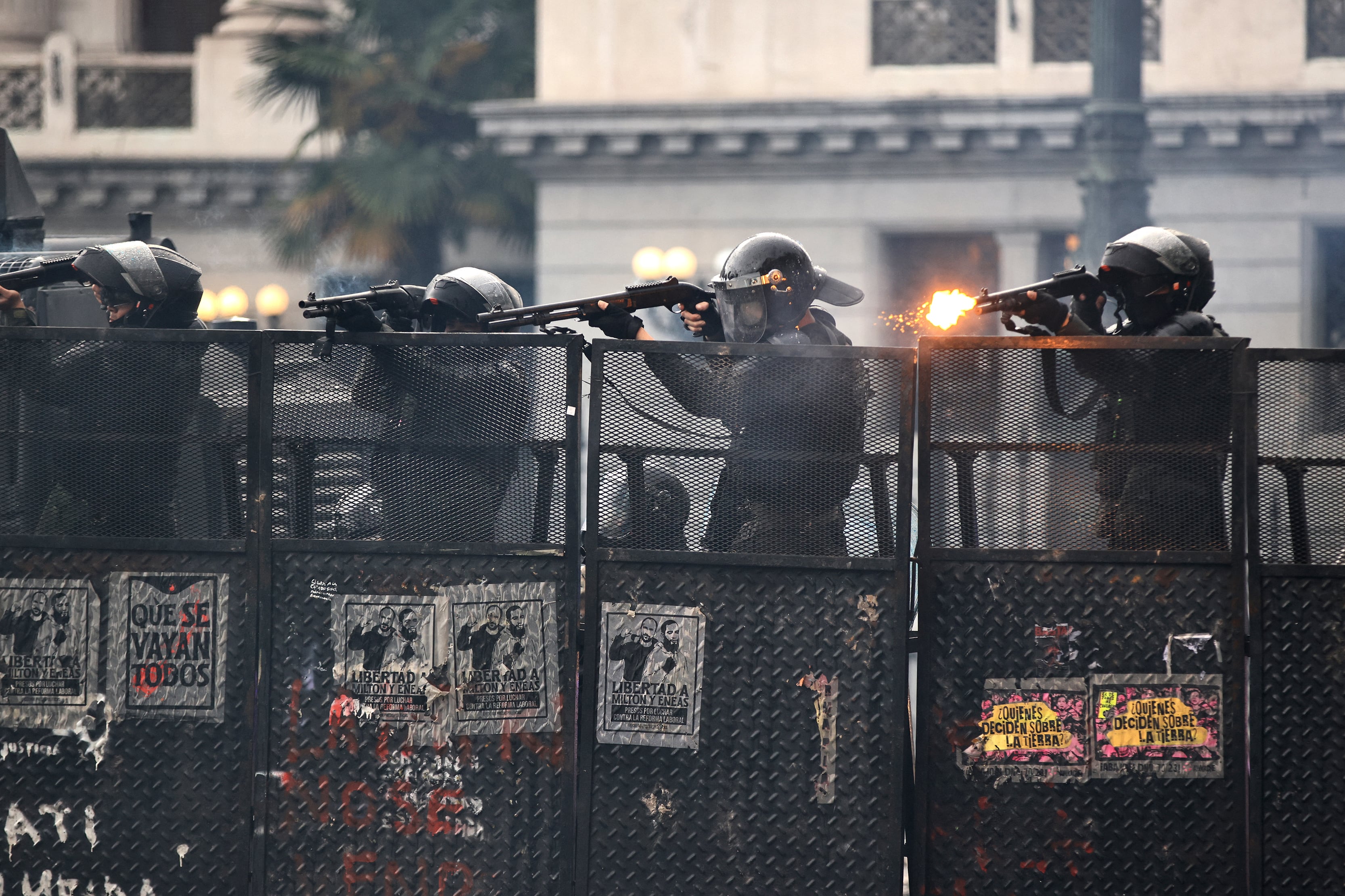 Members of the Argnetina's National Guard fire their weapons amid clashes during a demonstration against the government of Argentina's President Javier Milei