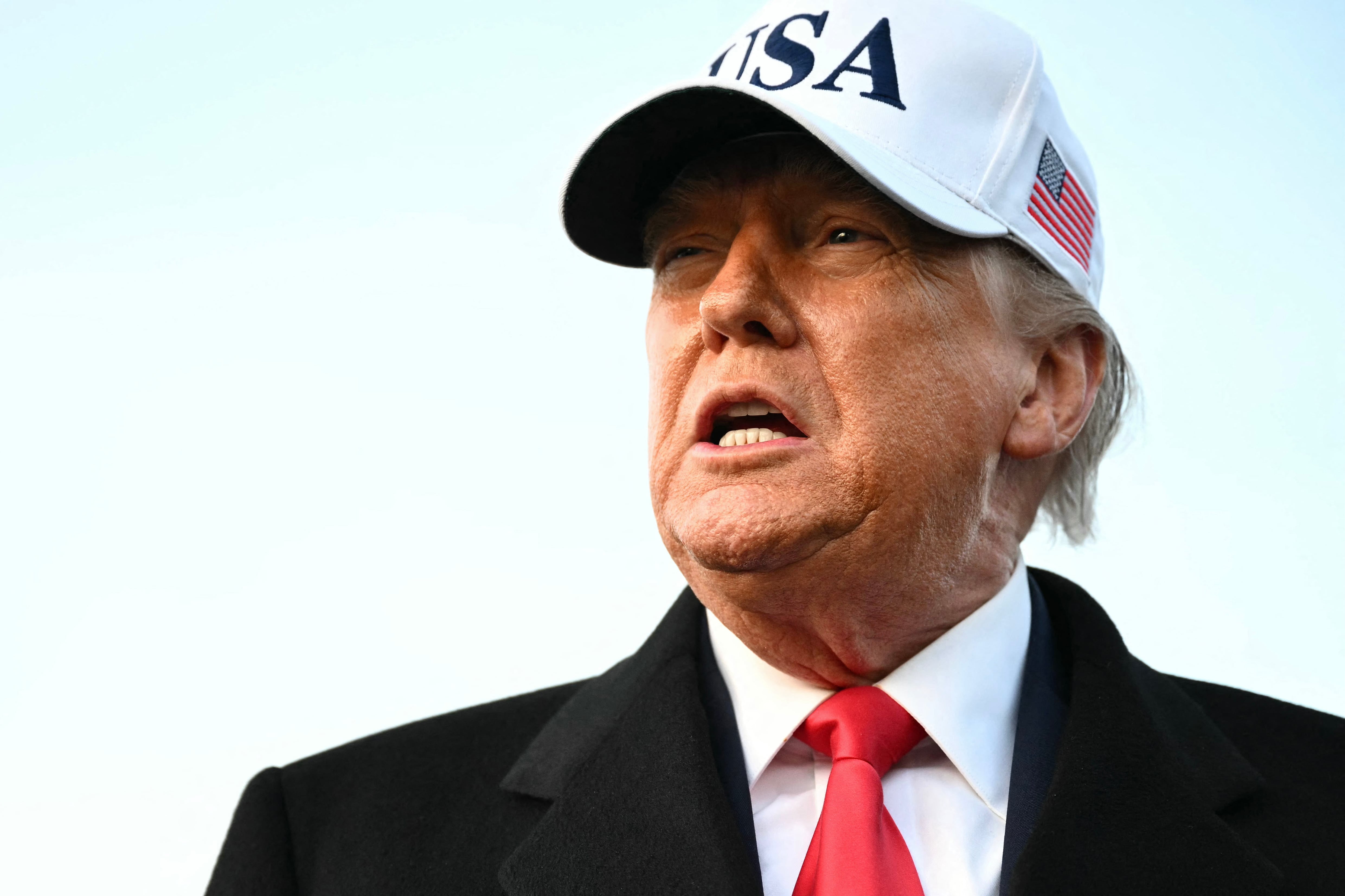 US President Donald Trump speaks to the press upon returning to Joint Base Andrews in Maryland on January 13, 2026. Trump is returning from speaking to The Detroit Economic Club in Detroit, Michigan, and a visit to a Ford production plant. (Photo by Mandel NGAN / AFP)