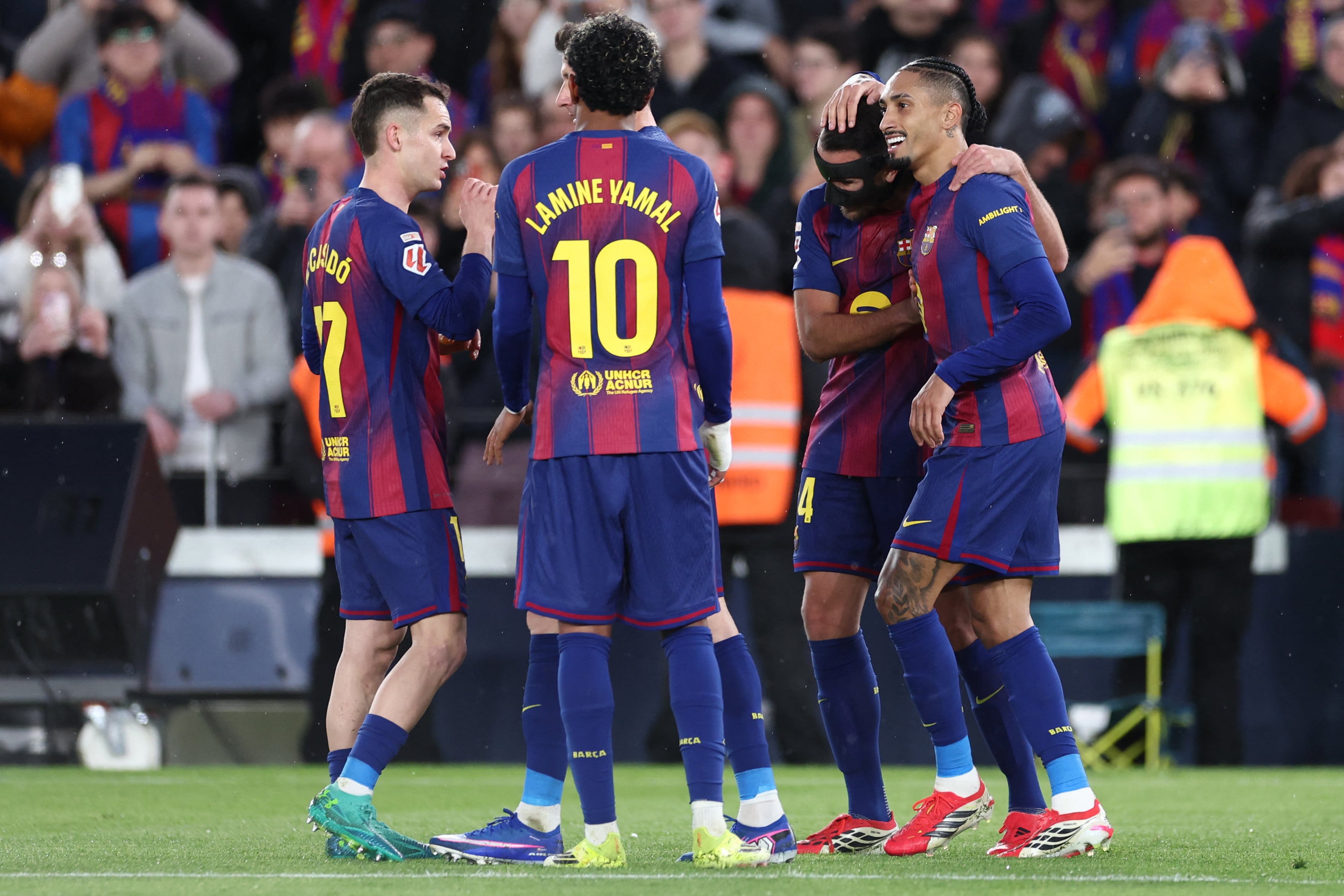 Barcelona's Brazilian forward #11 Raphinha (R) celebrates scoring his team's second goal during the Spanish league football match between FC Barcelona and Real Oviedo at Camp Nou Stadium in Barcelona on January 25, 2026. (Photo by Josep LAGO / AFP)
