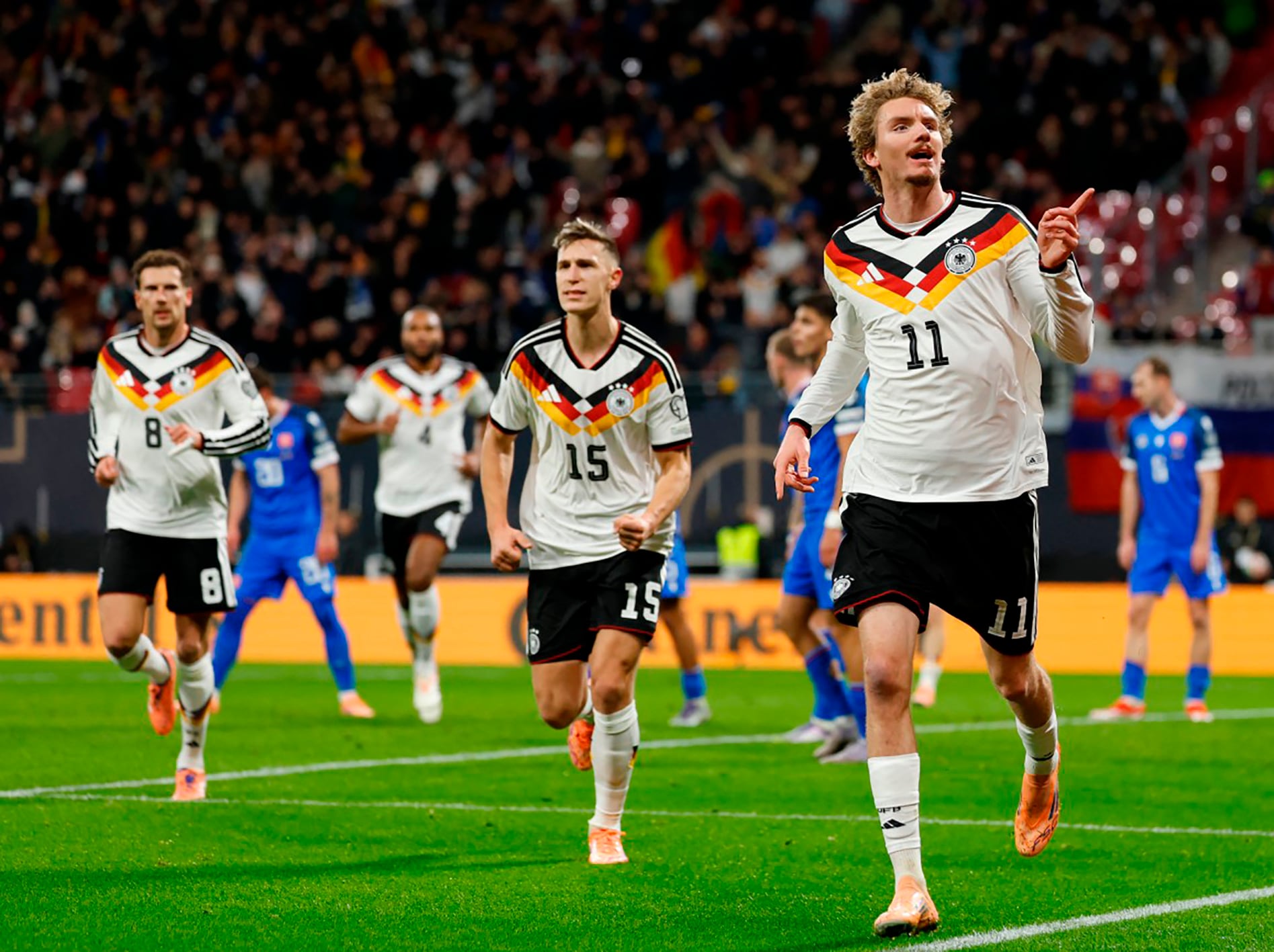 Germany's forward #11 Nick Woltemade (R) celebrates scoring his team's first goal during the FIFA World Cup 2026 European qualification Group A football match between Germany and Slovakia, at the Red Bull Arena in Leipzig, eastern Germany on November 17, 2025. (Photo by Odd ANDERSEN / AFP)