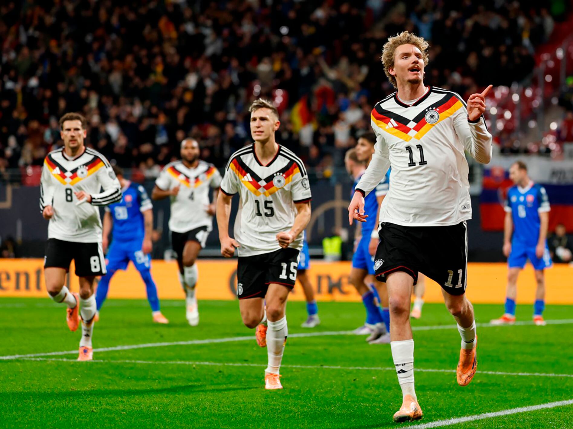 Germany's forward #11 Nick Woltemade (R) celebrates scoring his team's first goal during the FIFA World Cup 2026 European qualification Group A football match between Germany and Slovakia, at the Red Bull Arena in Leipzig, eastern Germany on November 17, 2025. (Photo by Odd ANDERSEN / AFP)