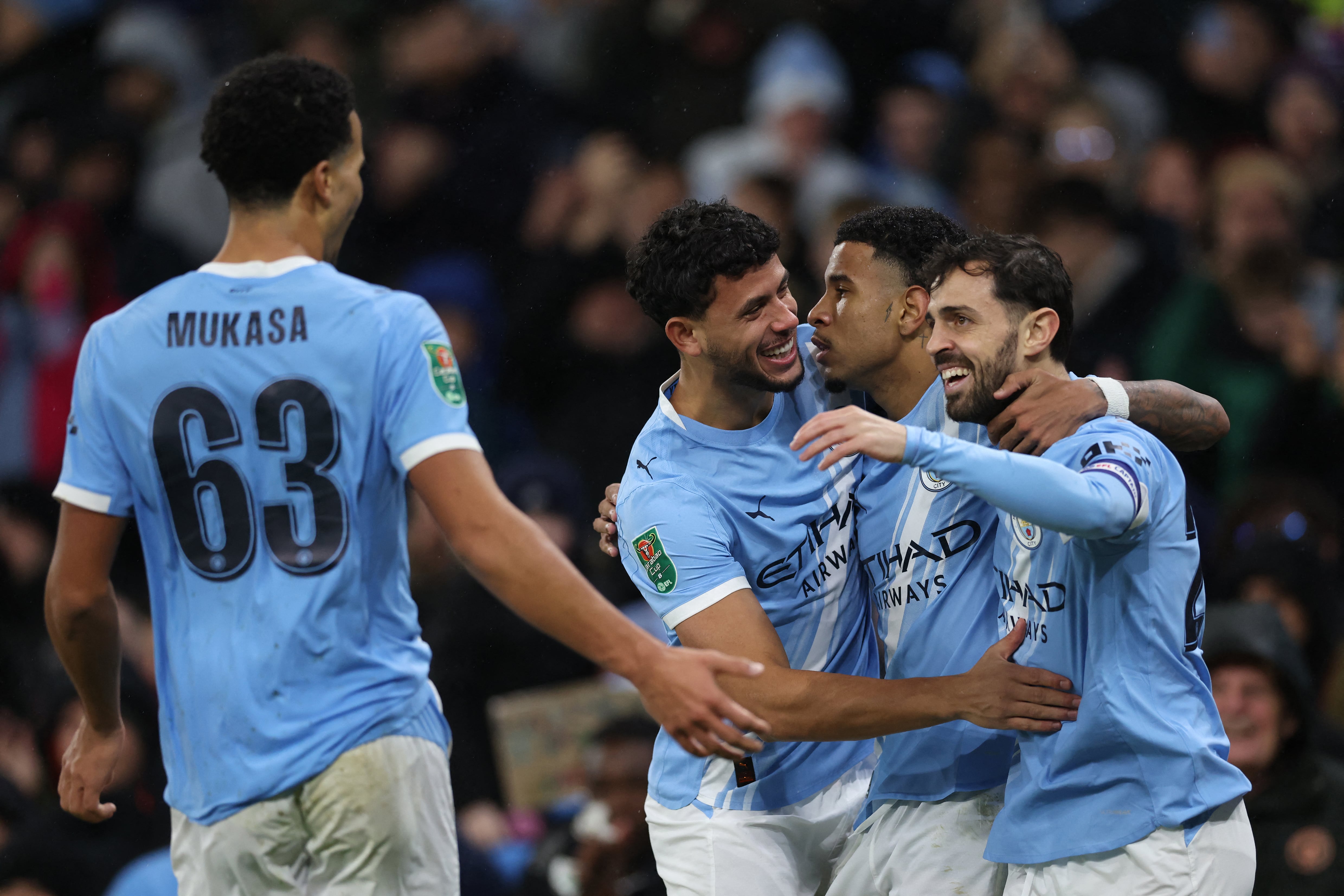 Manchester City's Brazilian midfielder #26 Savinho (2R) celebrates scoring their second goal during the English League Cup quarter-final football match between Manchester City and Brentford at the Etihad stadium in Manchester, northwest England on December 17, 2025. (Photo by Darren Staples / AFP) / RESTRICTED TO EDITORIAL USE. NO USE WITH UNAUTHORIZED AUDIO, VIDEO, DATA, FIXTURE LISTS, CLUB/LEAGUE LOGOS OR 'LIVE' SERVICES. ONLINE IN-MATCH USE LIMITED TO 120 IMAGES. AN ADDITIONAL 40 IMAGES MAY BE USED IN EXTRA TIME. NO VIDEO EMULATION. SOCIAL MEDIA IN-MATCH USE LIMITED TO 120 IMAGES. AN ADDITIONAL 40 IMAGES MAY BE USED IN EXTRA TIME. NO USE IN BETTING PUBLICATIONS, GAMES OR SINGLE CLUB/LEAGUE/PLAYER PUBLICATIONS. /