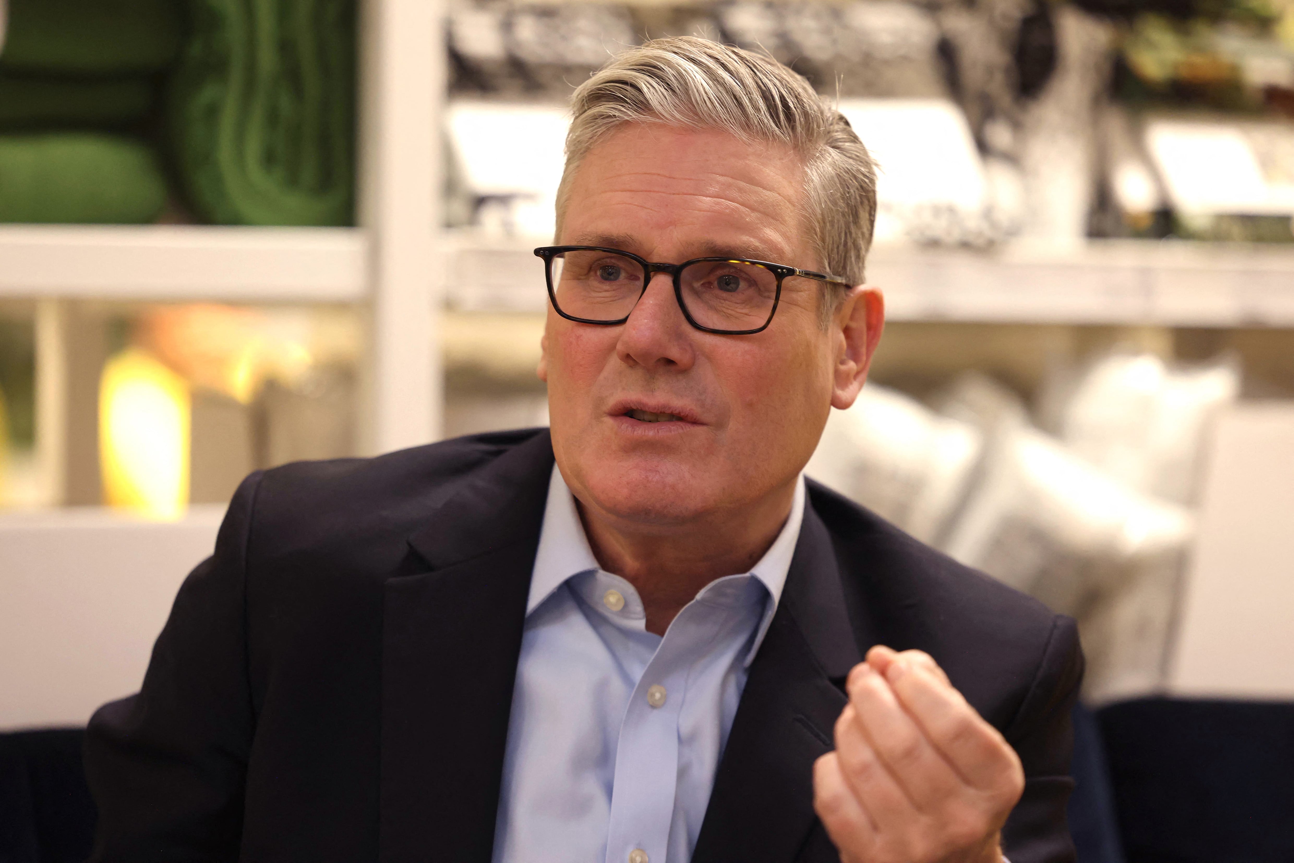 Britain's Prime Minister Keir Starmer speaks with members of staff during a visit to a branch of Swedish furniture store Ikea in Croydon, south London on January 12, 2026. (Photo by Ian Vogler / POOL / AFP)