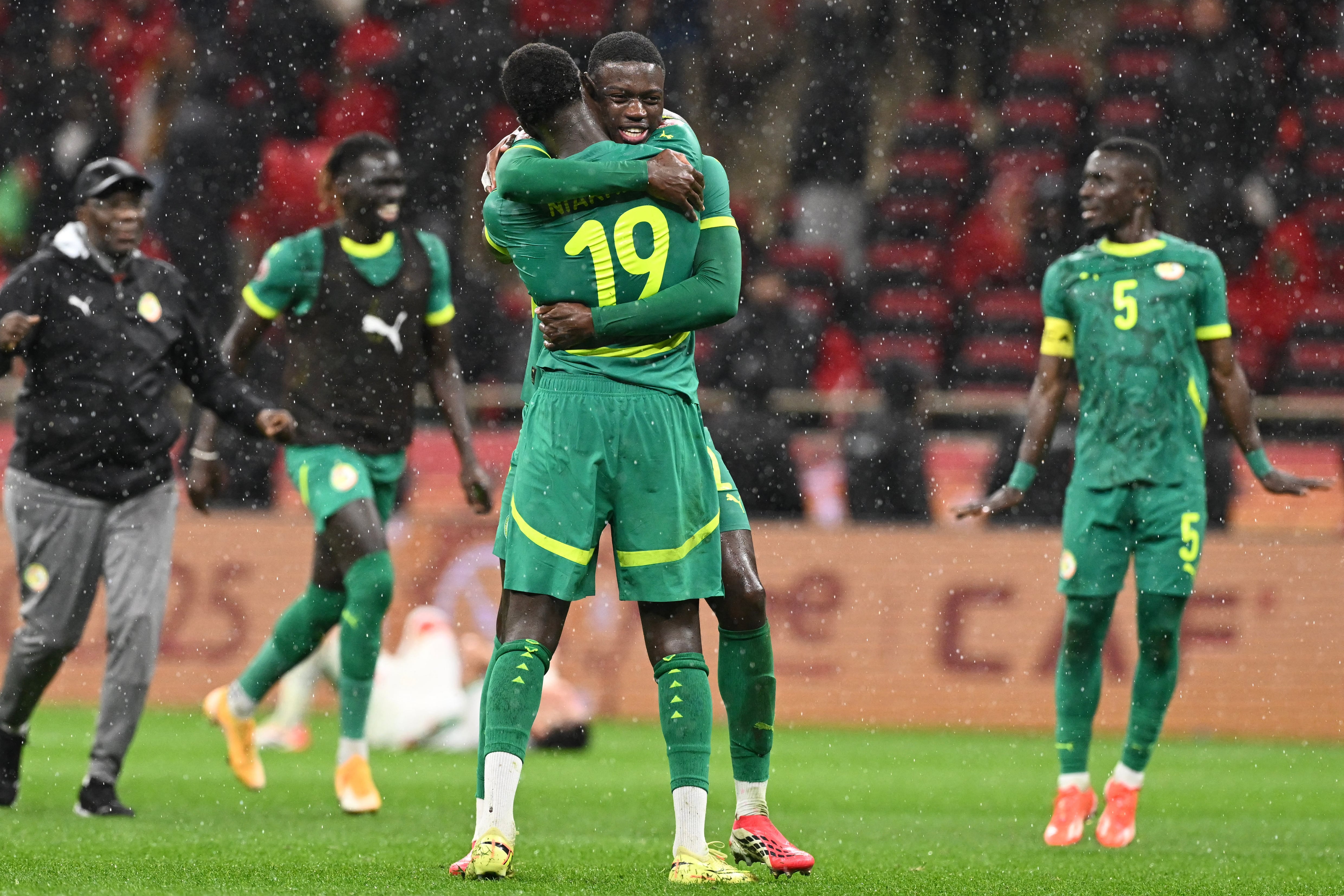 Senegal's defender #19 Moussa Niakhate and Senegal's defender #02 Mamadou Sarr celebrate after the Africa Cup of Nations (CAN) final football match between Senegal and Morocco at the Prince Moulay Abdellah Stadium in Rabat on January 18, 2026. (Photo by SEBASTIEN BOZON / AFP)