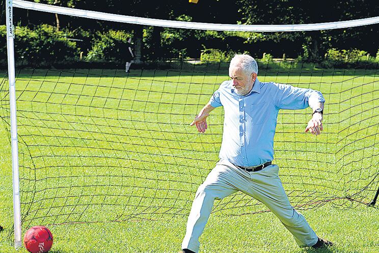 Corbyn juega al fútbol con niños en un parque de Londres durante un evento de campaña.