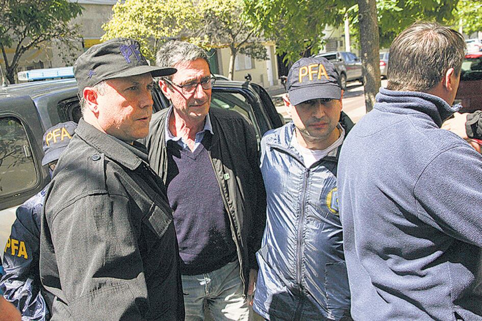 Aníbal Prina, rodeado de policías, tras su detención.