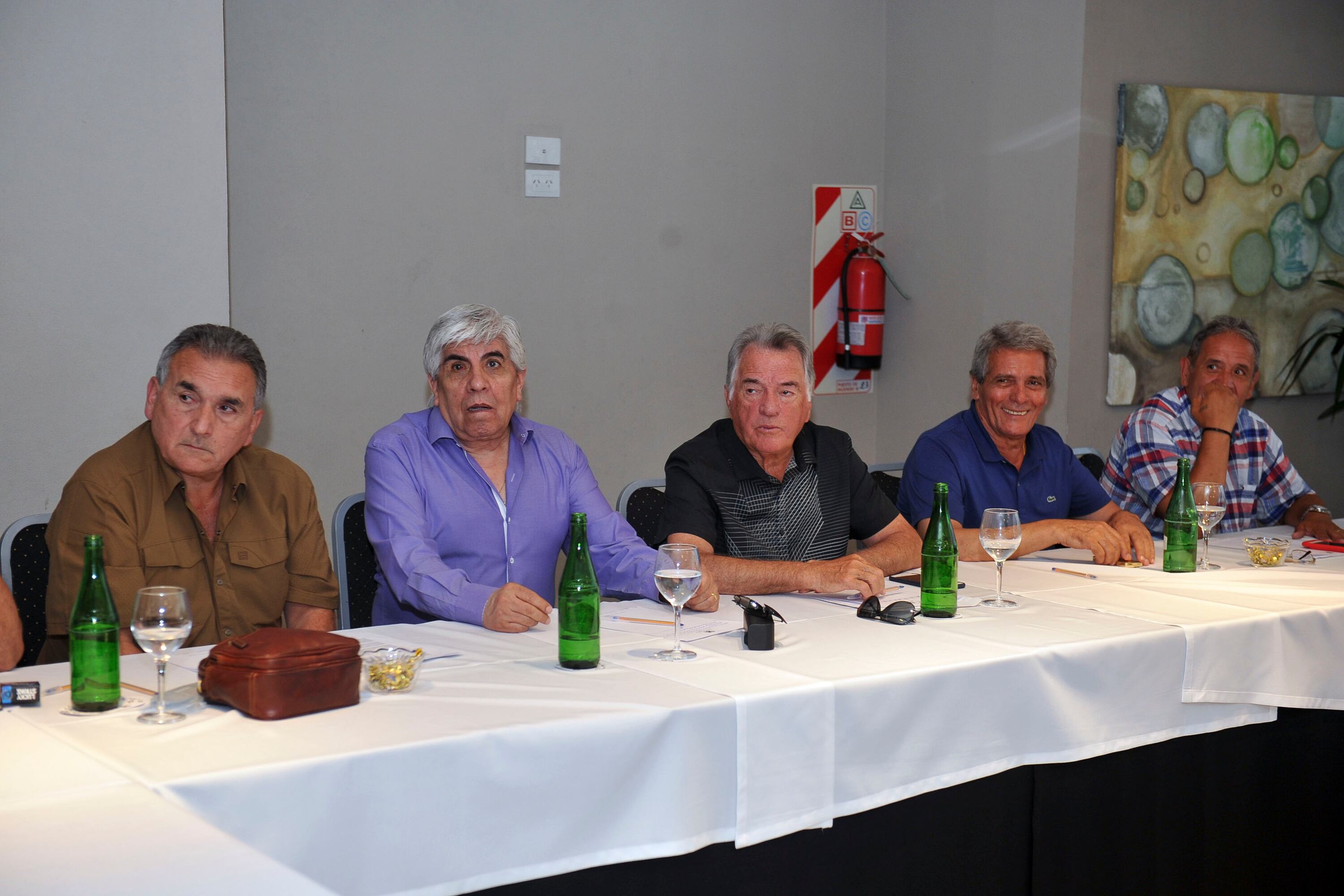 Juan Carlos Schmid habla en la cumbre marplatense, sentado junto a Hugo Moyano.