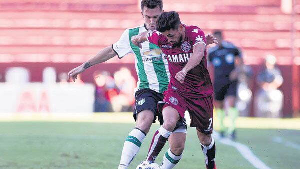 Laucha Acosta cuida la pelota frente a la presión del rival.