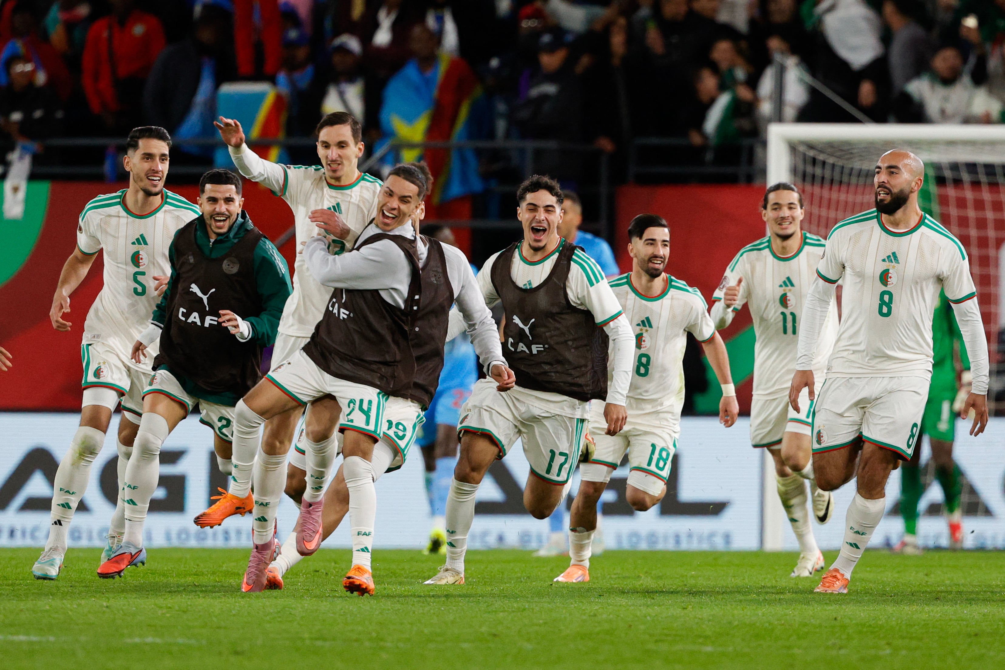 Algeria's forward #27 Adil Boulbina (3L) who scored his team's first goal celebrates with teammates after the Africa Cup of Nations (CAN) round of 16 football match between Algeria and Democratic Republic of Congo at the Prince Moulay El Hassan stadium in Rabat on January 6, 2026. (Photo by Abdel Majid BZIOUAT / AFP)