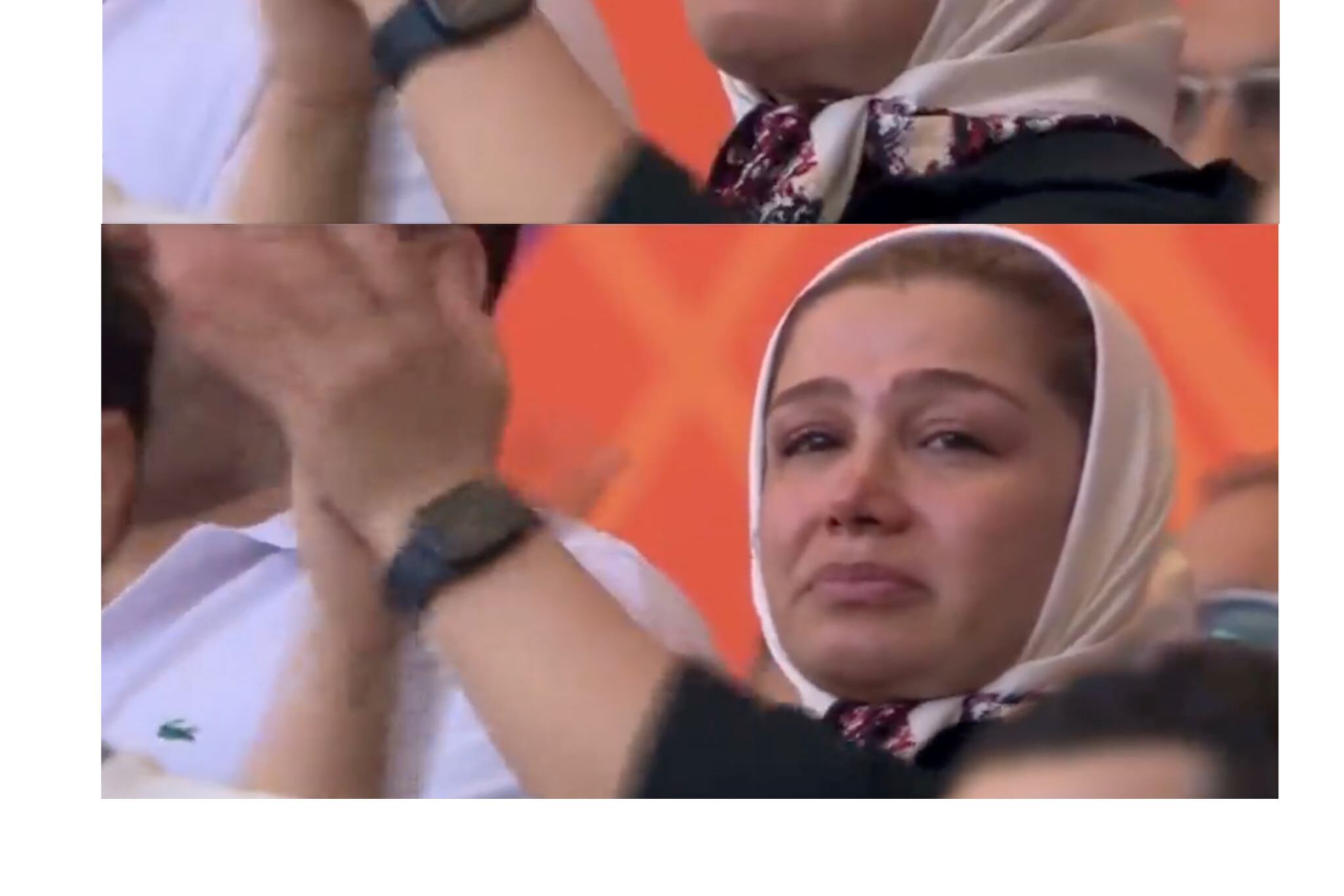 Una mujer de hijab blanco llora emocionada en el primer partido de Irán, cuando los jugadores no cantaron el himno.
