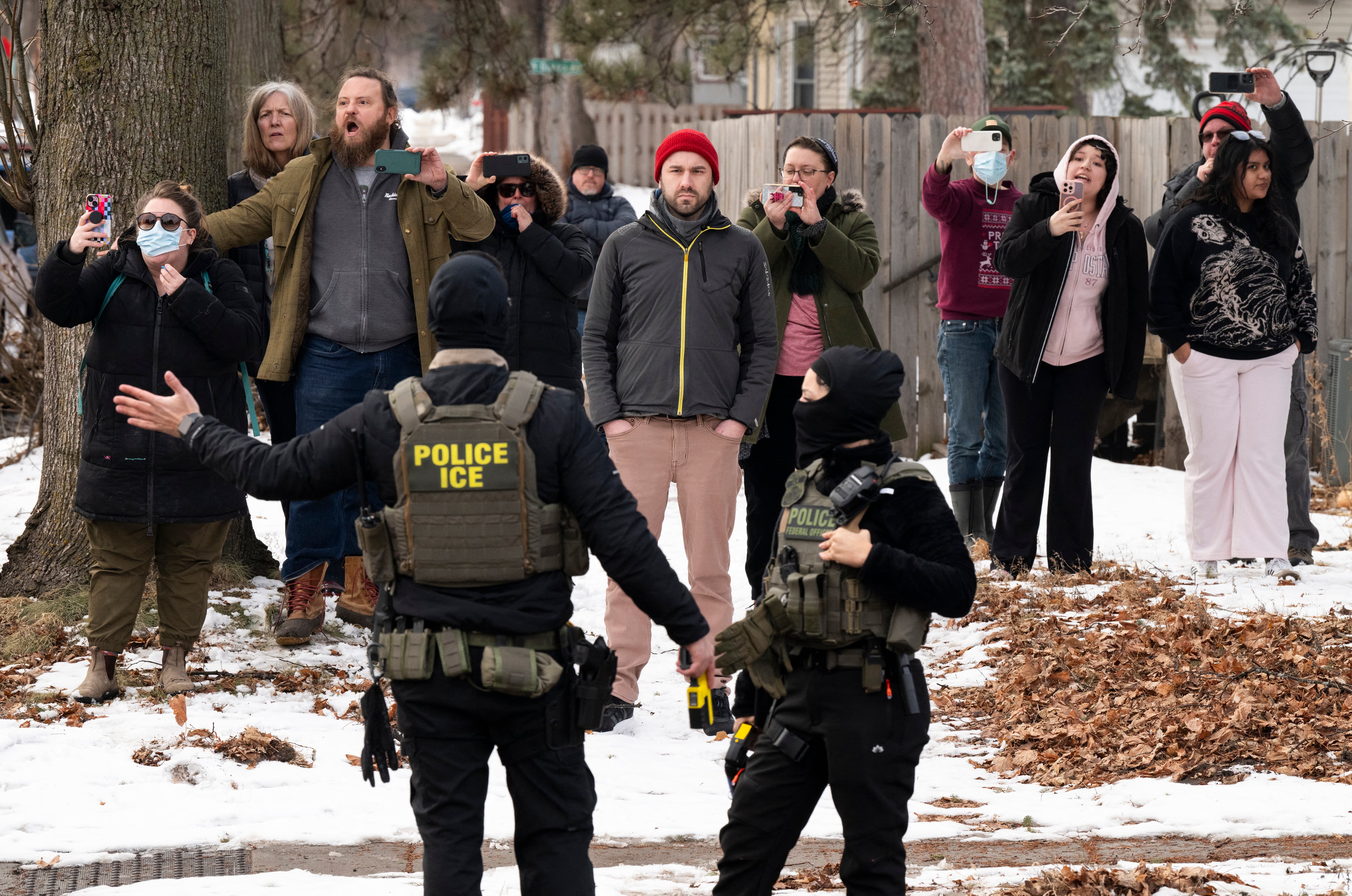 MINNEAPOLIS, MINNESOTA - FEBRUARY 05: Observers film ICE agents as they hold a perimeter after one of their vehicles got a flat tire on Penn Avenue on February 5, 2026 in Minneapolis, Minnesota. Protests continue calling for an end to immigration raids in the Twin cities which have already resulted in the fatal shooting deaths of Alex Pretti, a VA nurse, and Renee Good, a mother of three, by federal agents.   Stephen Maturen/Getty Images/AFP (Photo by Stephen Maturen / GETTY IMAGES NORTH AMERICA / Getty Images via AFP)