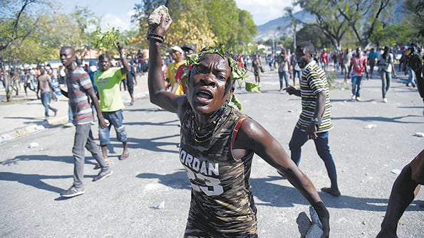 Un joven se manifiesta frente al Palacio Nacional en contra del presidente Jovenel Moise.