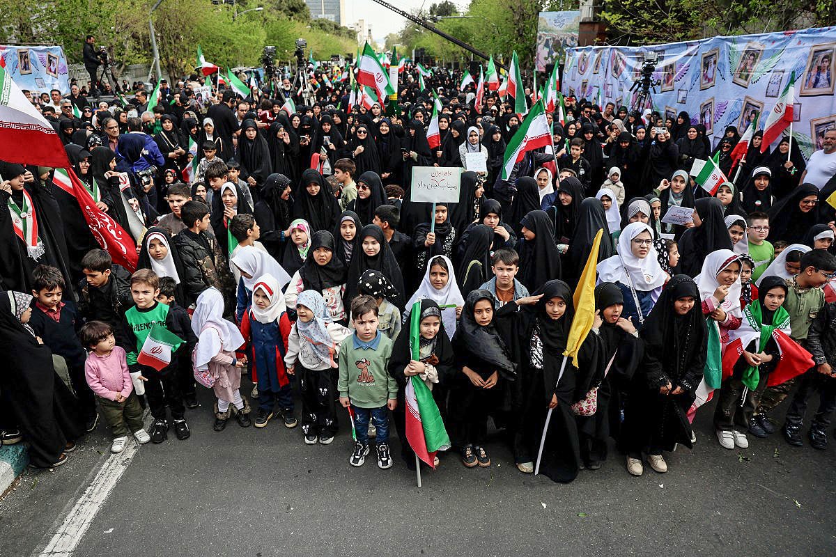 Iranians rally during a memorial, 40 days after a deadly strike on a children’s school in the southern city of Minab on the first day of the war that killed at least 165 people, most of them children, in Tehran on April 7, 2026. On February 28, Israel and the United States launched strikes on Iran, killing its supreme leader and triggering a war that spread across the Middle East. (Photo by AFP) /