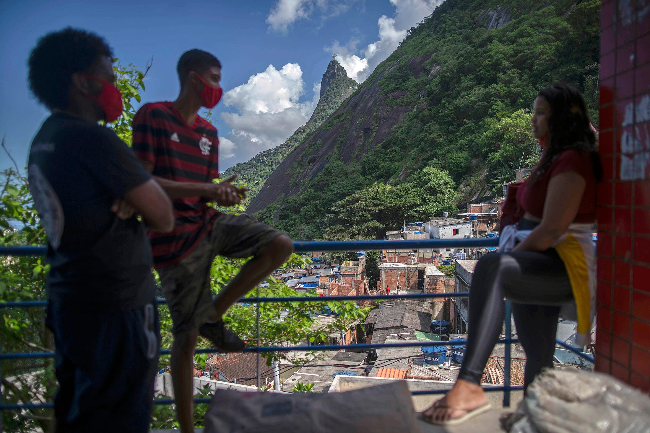 Un grupo de jóvenes convrsa en un balcón en la favela de Santa Marta, Río de Janeiro.