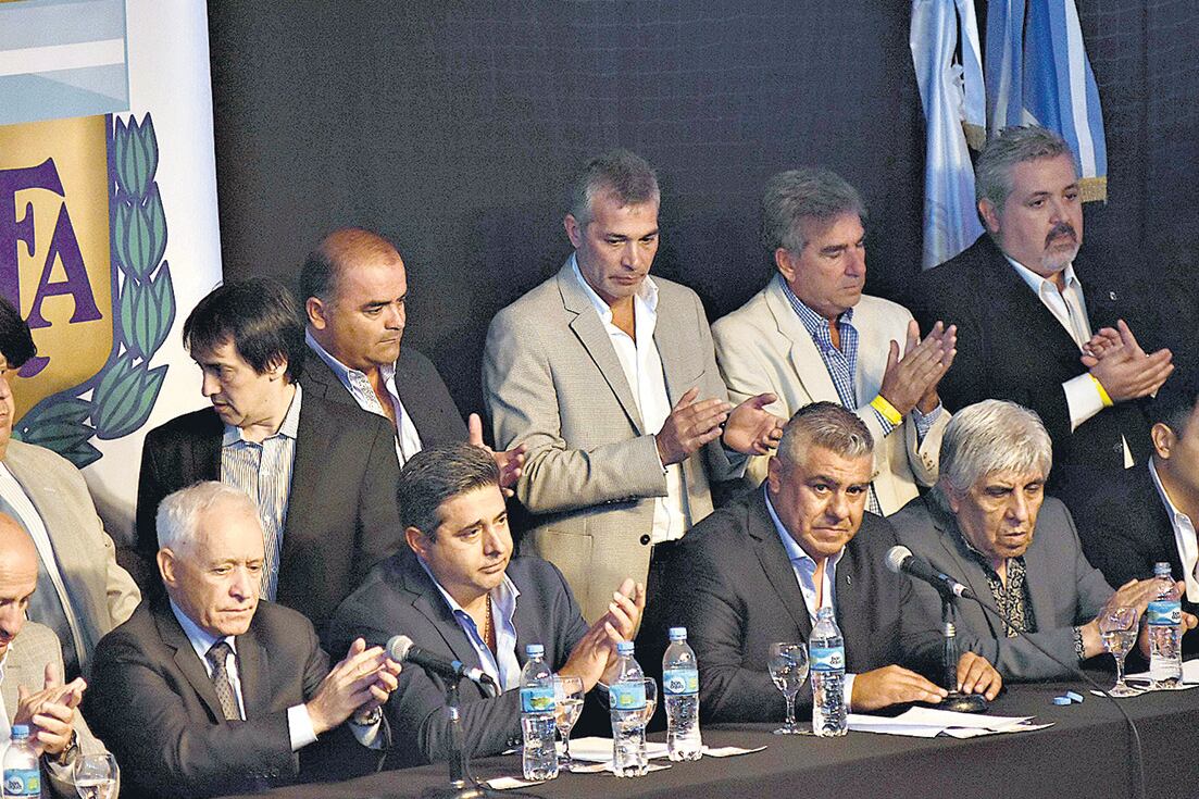 Claudio Tapia (entre Angelici y Moyano), junto a sus compañeros de la única lista que se presentó a la elección en el marco de la Asamblea Extraordinaria.