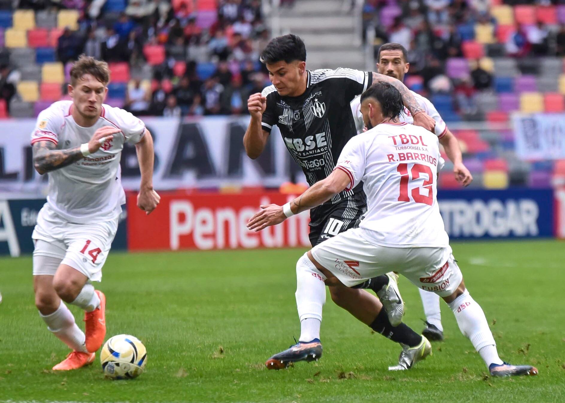 Gastón Verón, rodeado de defensores de Barracas.