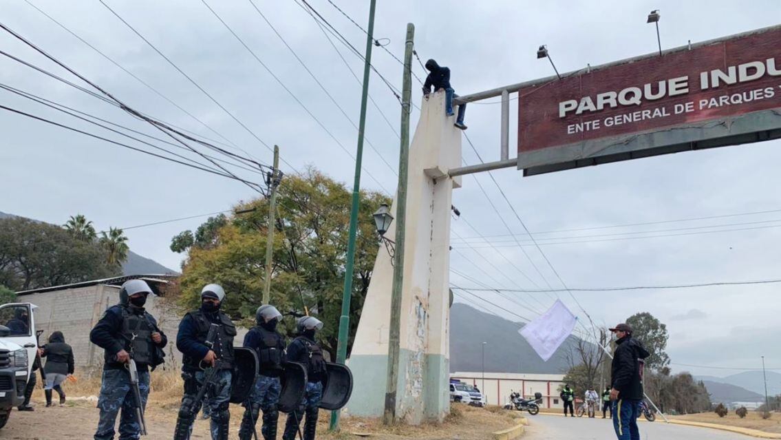 En protesta, un trabajador se subió al cartel del Parque Industrial. 