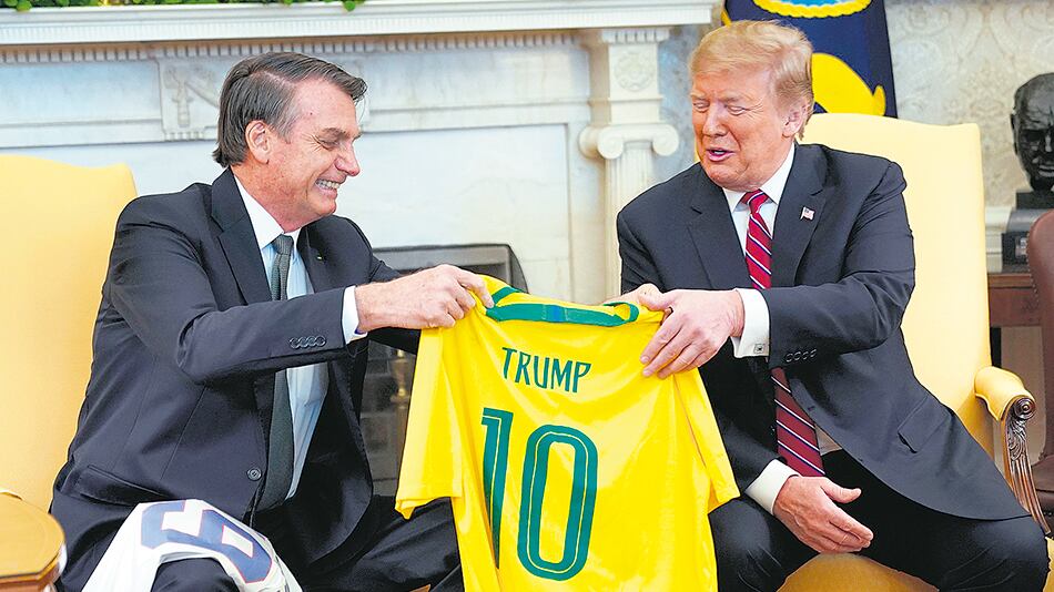 Bolsonaro le regala a Trump una camisteta del seleccionado brasileño con el nombre del mandatario de EE.UU. ayer en la Casa Blanca.