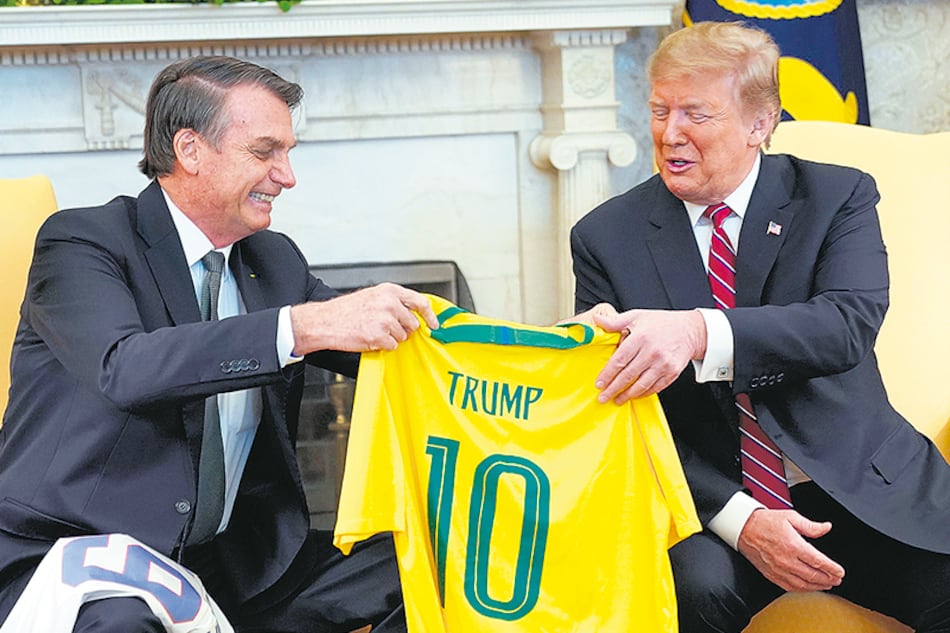 Bolsonaro le regala a Trump una camisteta del seleccionado brasileño con el nombre del mandatario de EE.UU. ayer en la Casa Blanca.
