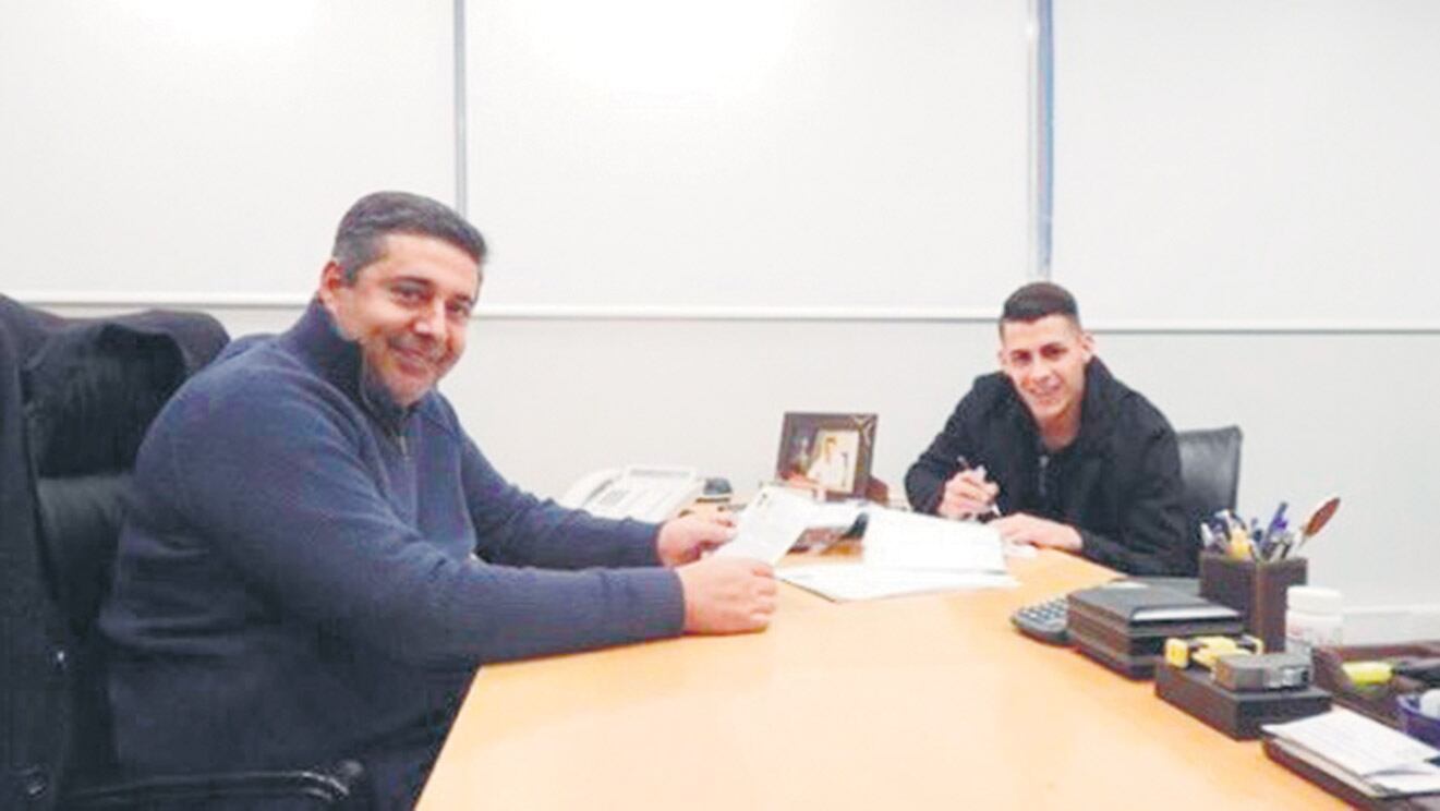 Cristian Pavón y Daniel Angelici, ayer durante la firma del nuevo vínculo.