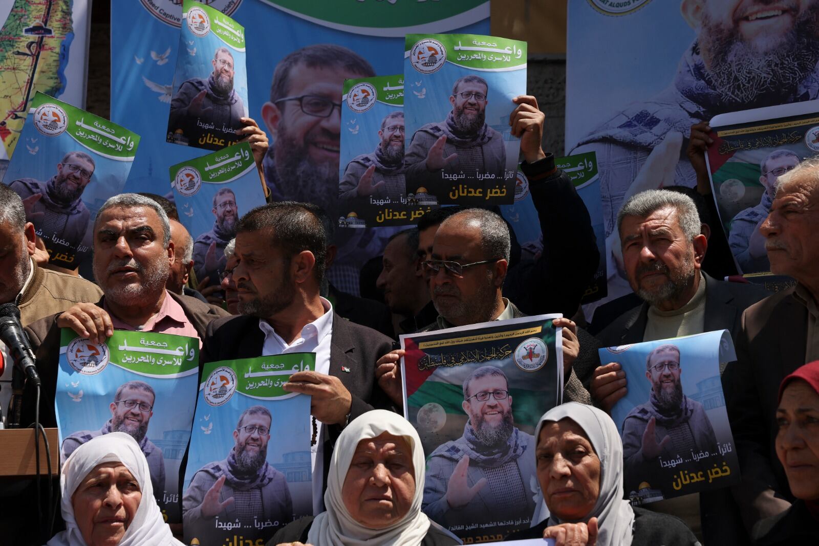 Manifestantes sostienen carteles de Adnán en Ciudad de Gaza antes del bombardeo israelí.